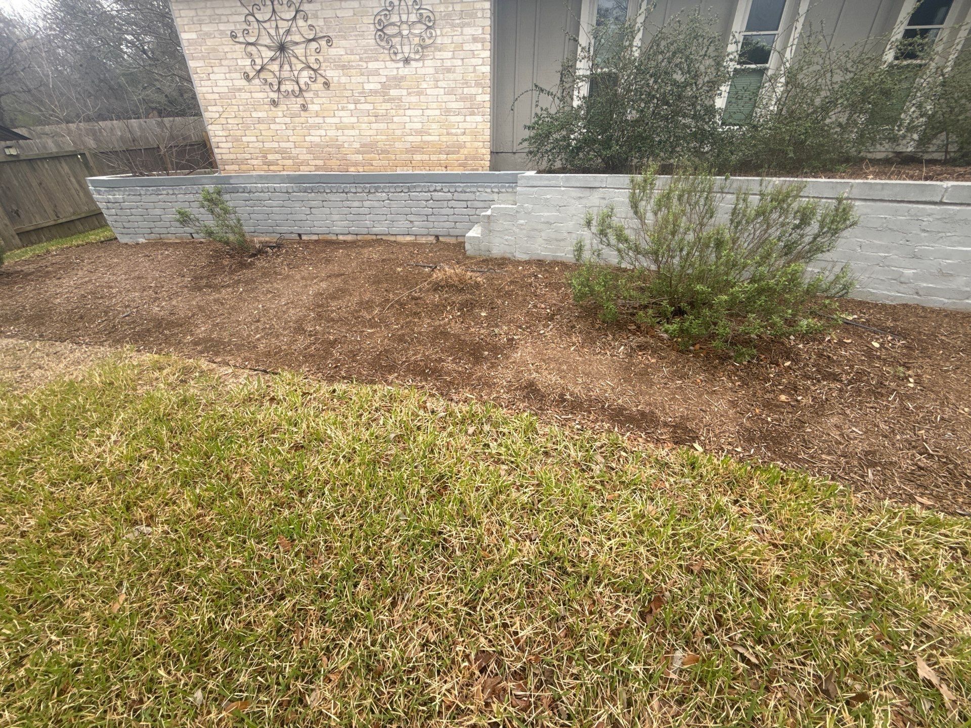 Exterior retaining wall ahead of painting in Austin, TX by Hill Country Painting