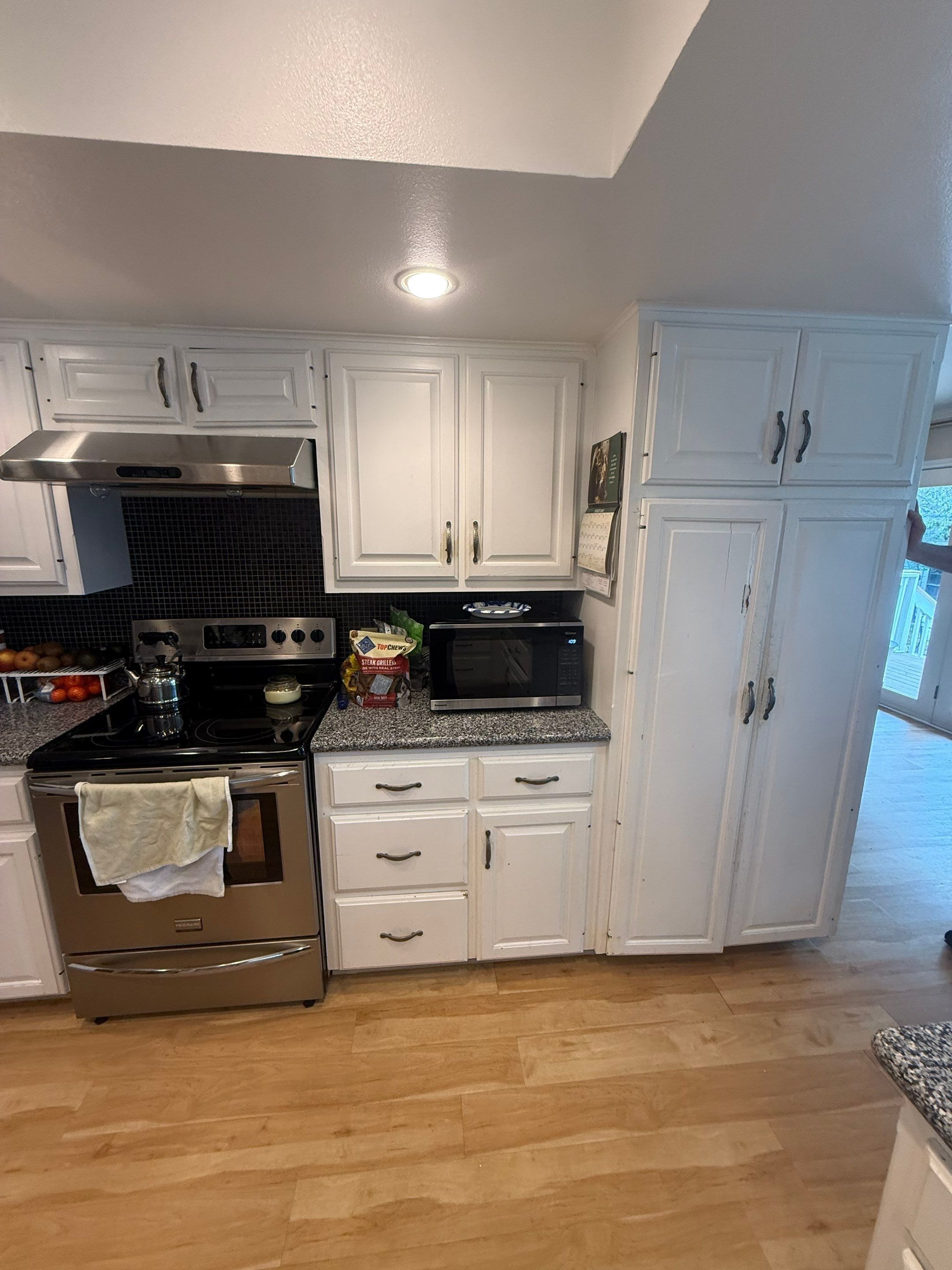 Pantry and range cabinetry ahead of cabinet painting in Austin, TX by Hill Country Painting