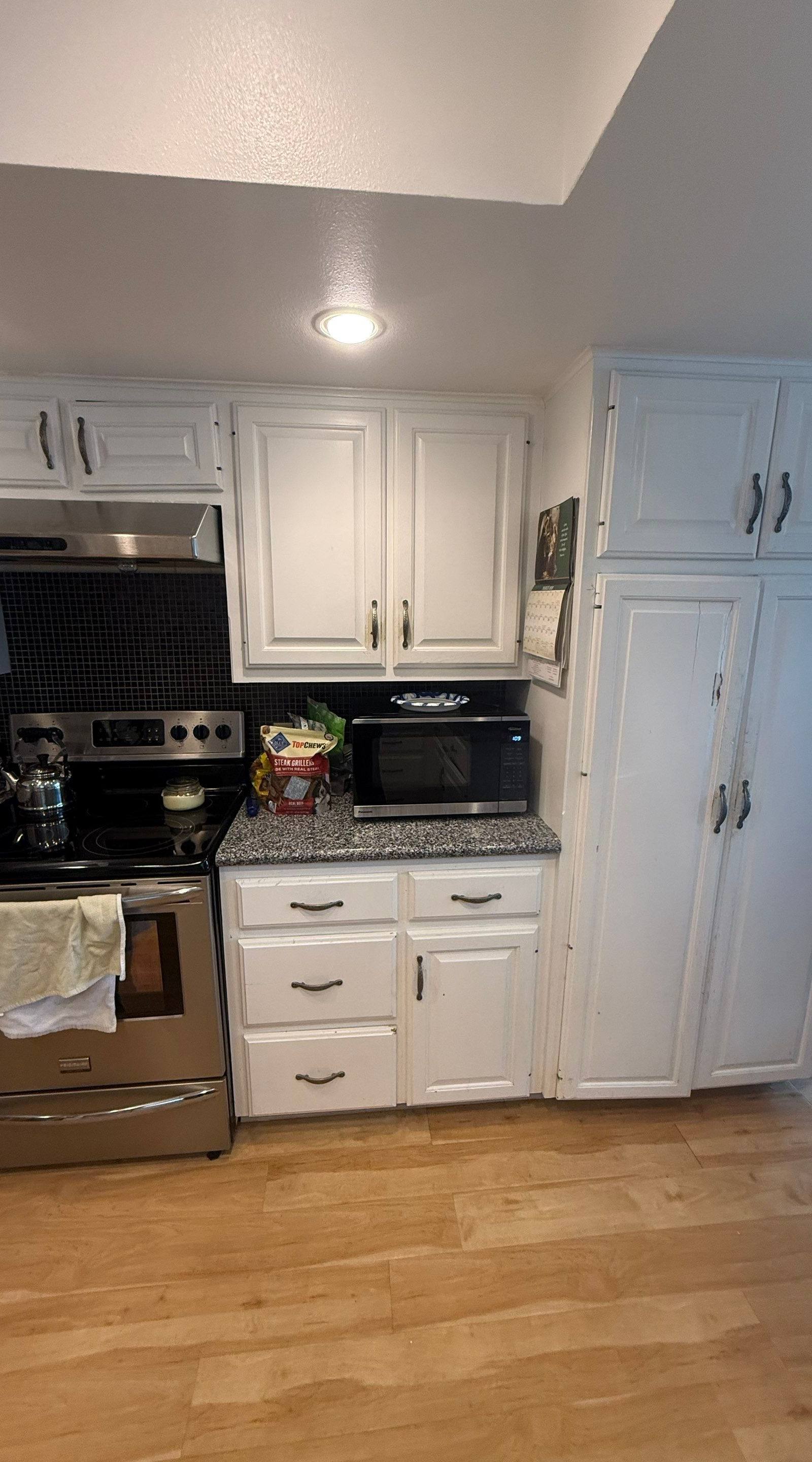 Pantry and range cabinetry ahead of cabinet painting in Austin, TX by Hill Country Painting