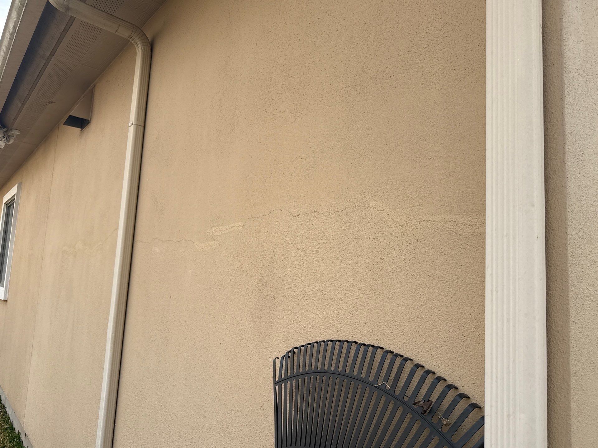 Stucco crack on exterior wall ahead of exterior painting in Cedar Park, TX by Hill Country Painting