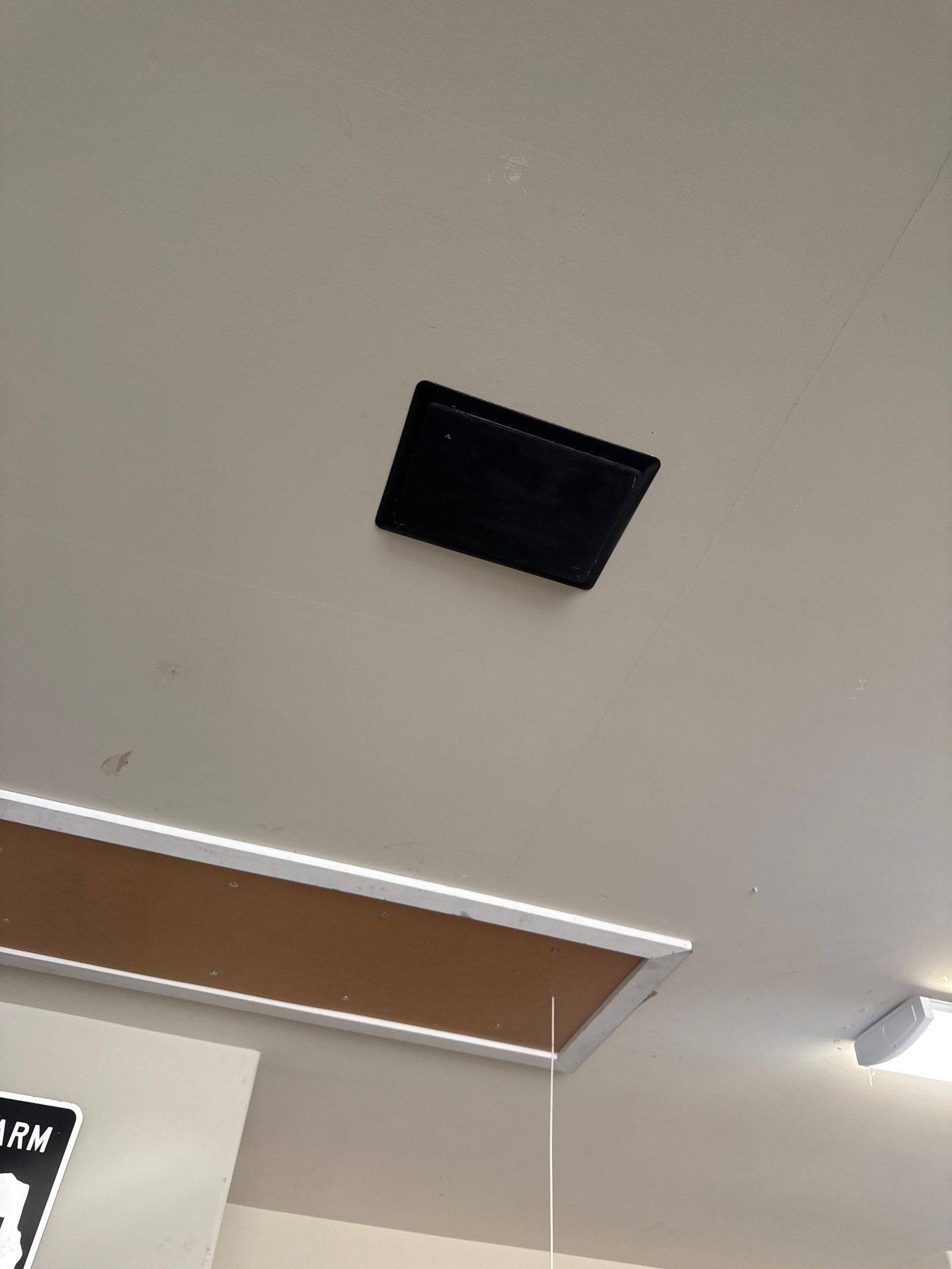 Garage ceiling speaker patch area ahead of garage painting in Cedar Park, TX by Hill Country Painting