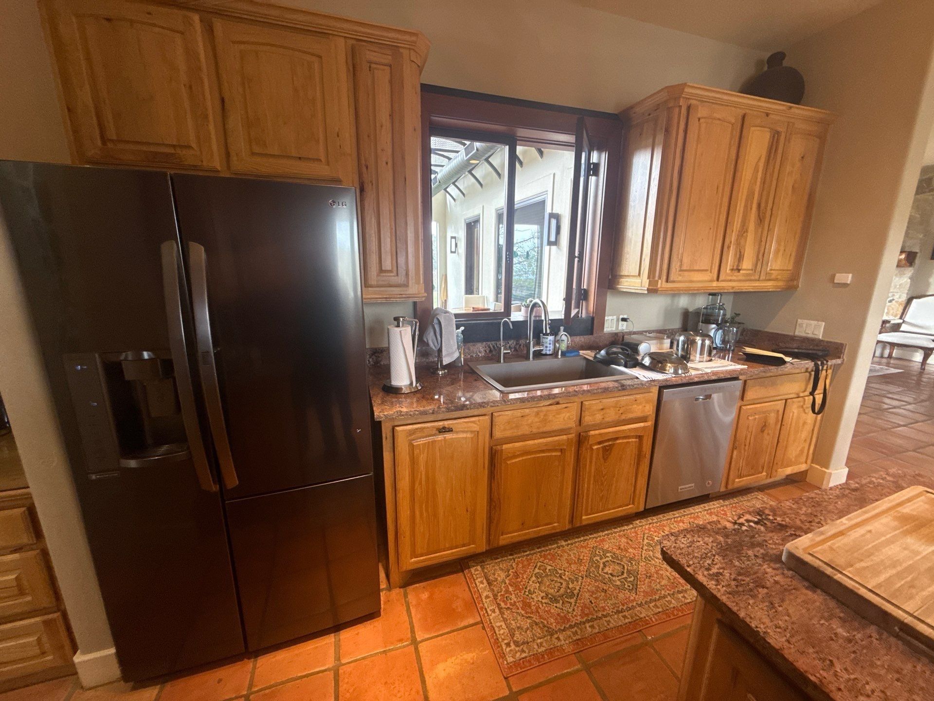 Kitchen cabinets, sink, and fridge ahead of cabinet painting in Austin, TX by Hill Country Painting