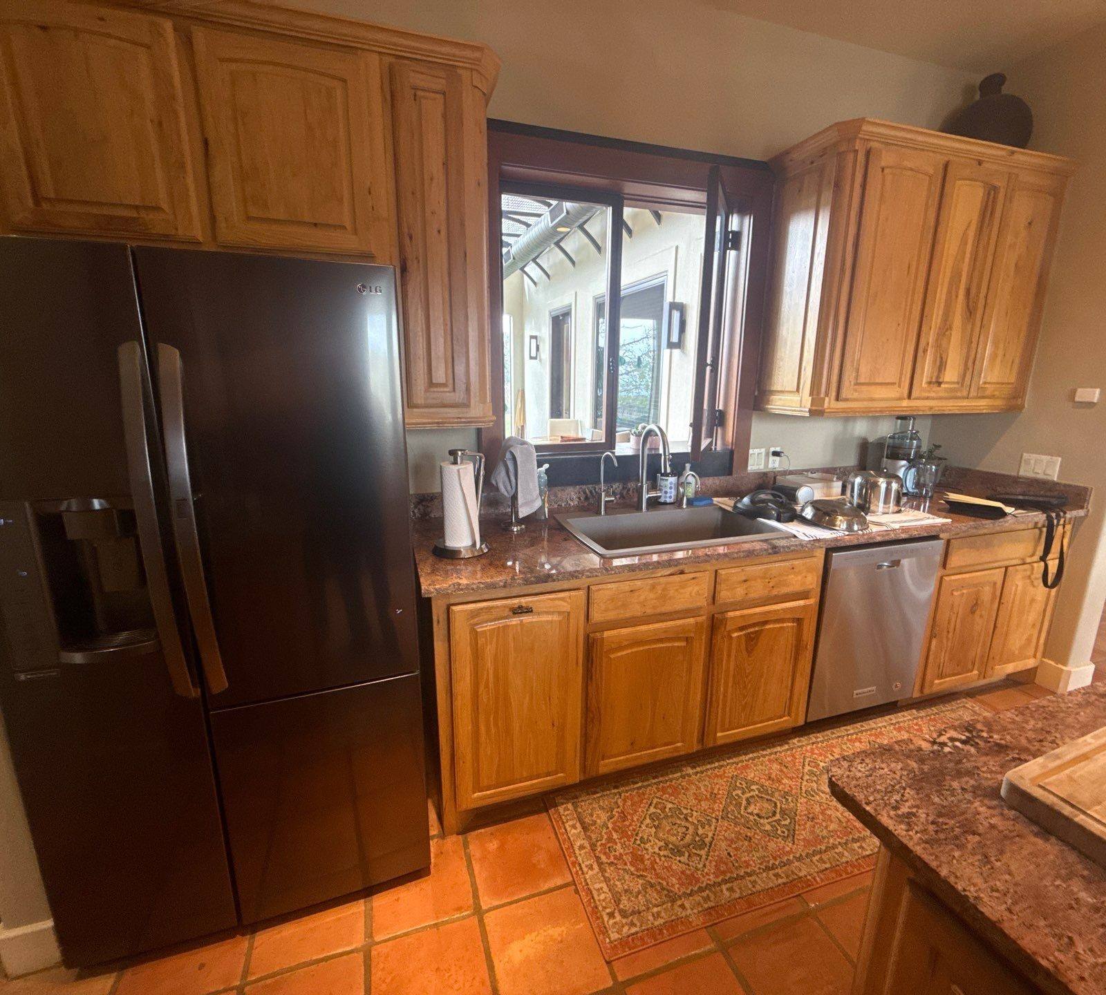 Kitchen cabinets, sink, and fridge ahead of cabinet painting in Austin, TX by Hill Country Painting