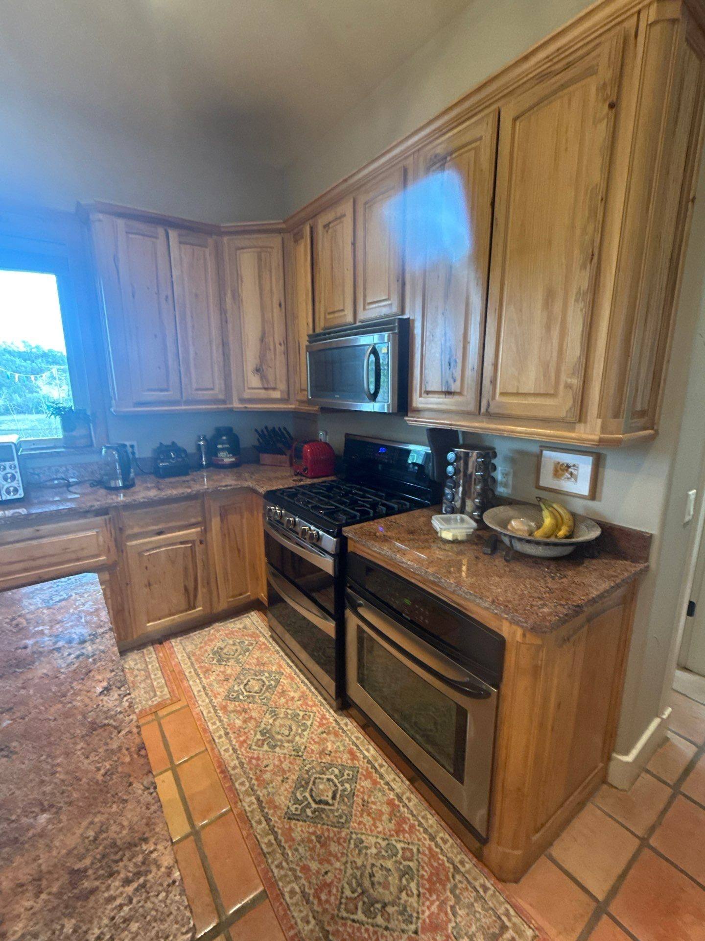 Range and oven cabinetry ahead of cabinet painting in Austin, TX by Hill Country Painting