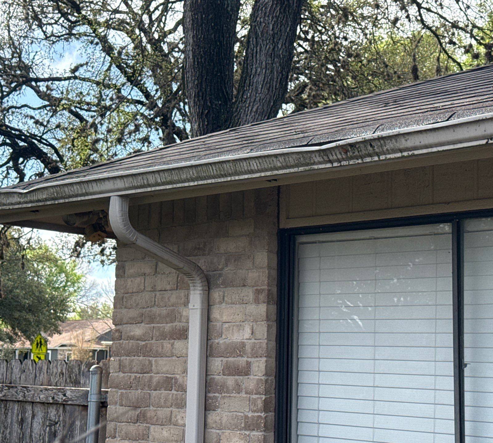 Back corner and gutters ahead of exterior painting in Austin, TX by Hill Country Painting