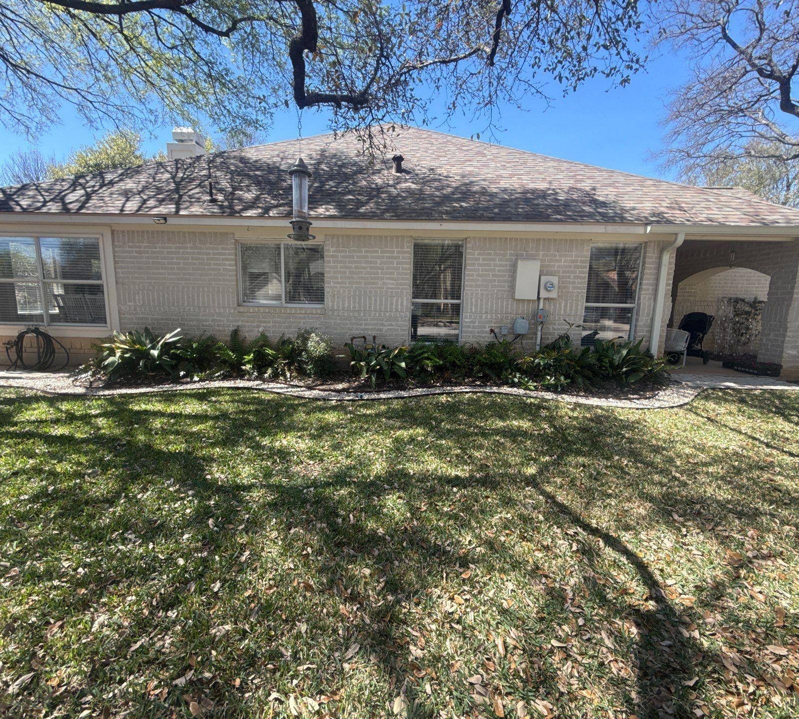 Left side of house ahead of exterior painting in Cedar Park, TX by Hill Country Painting