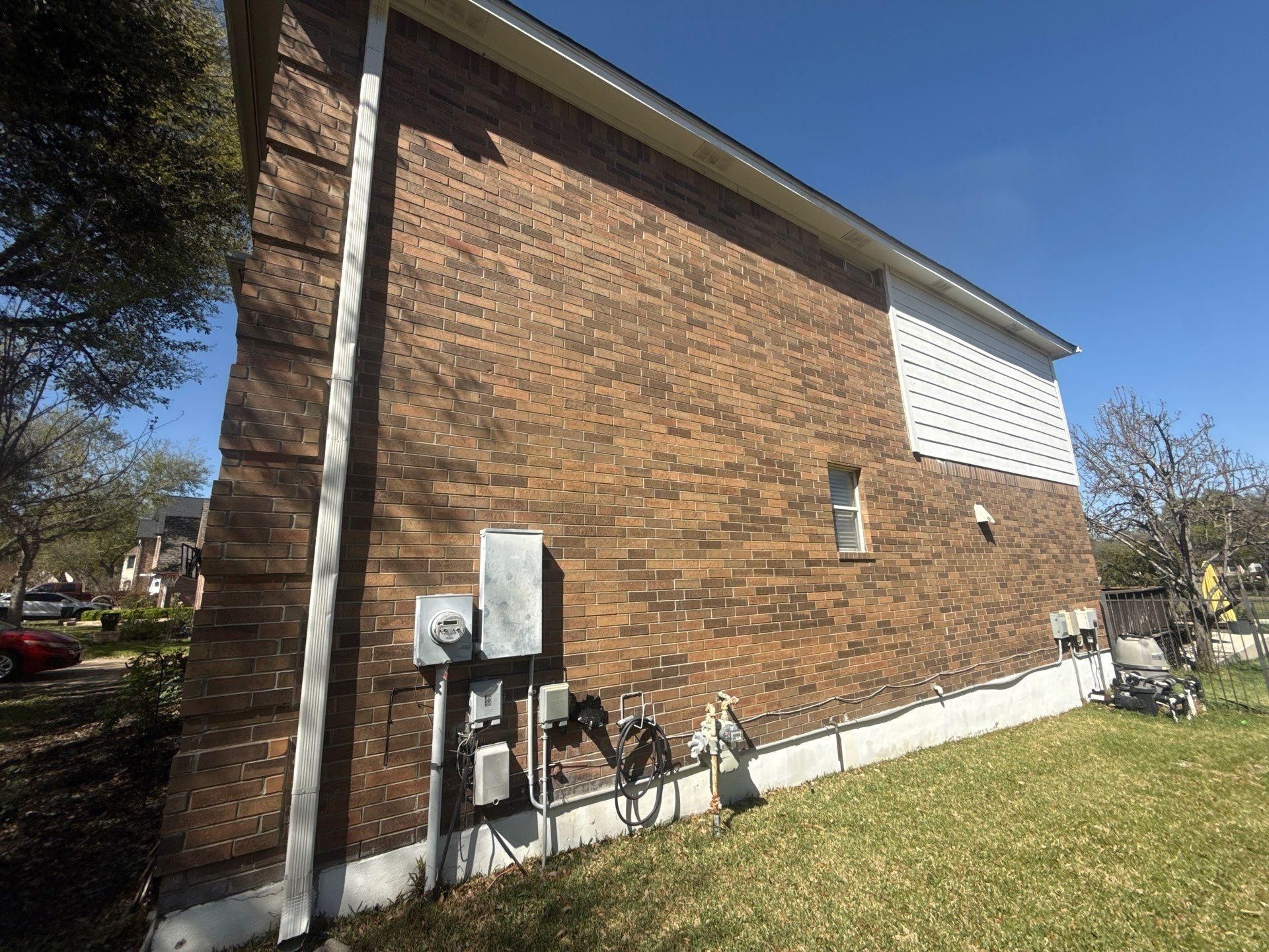 Side of house ahead of exterior painting in Round Rock, TX by Hill Country Painting