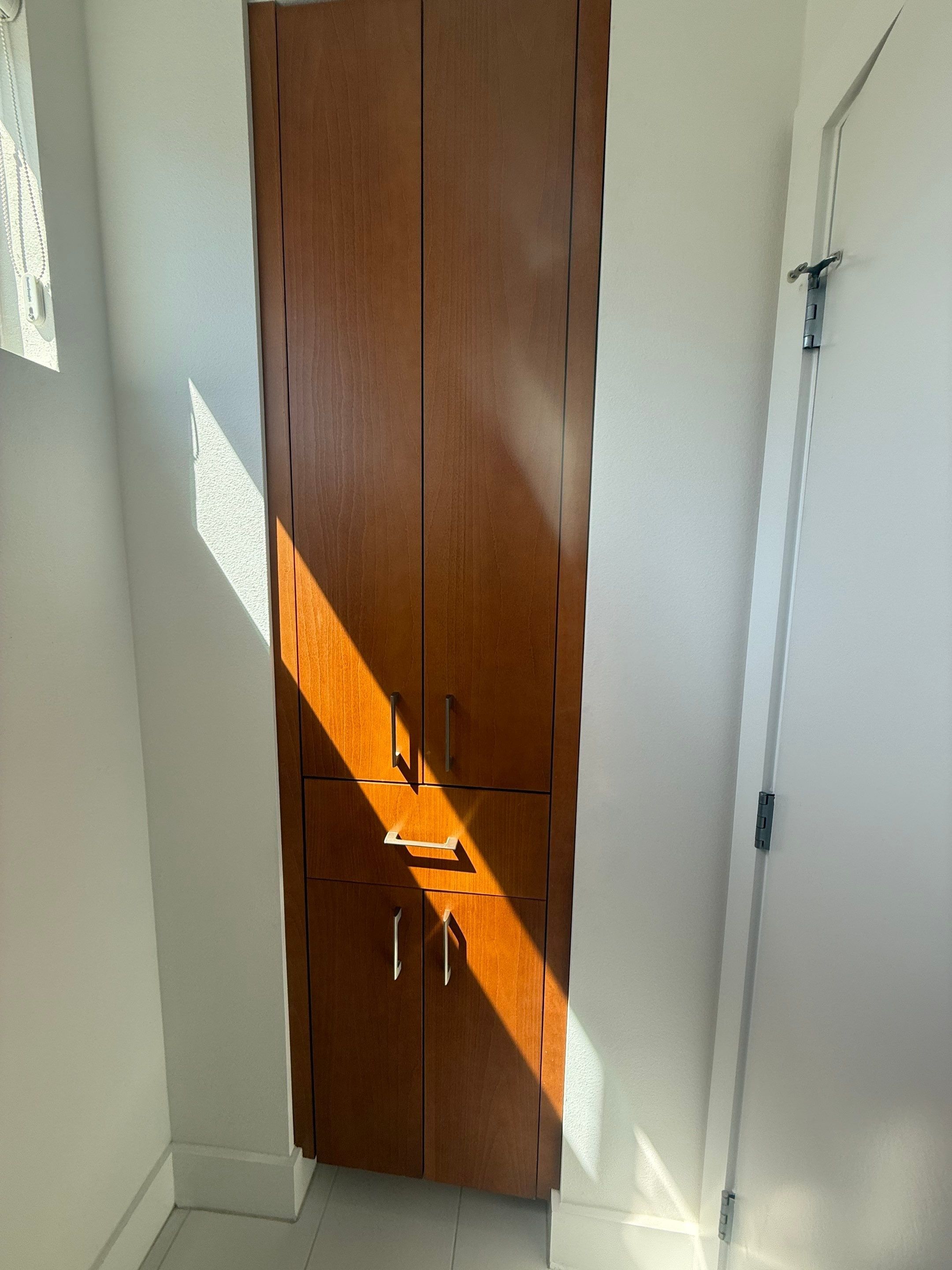 Linen cabinet in the master bathroom ahead of painting in Austin, TX by Hill Country Painting