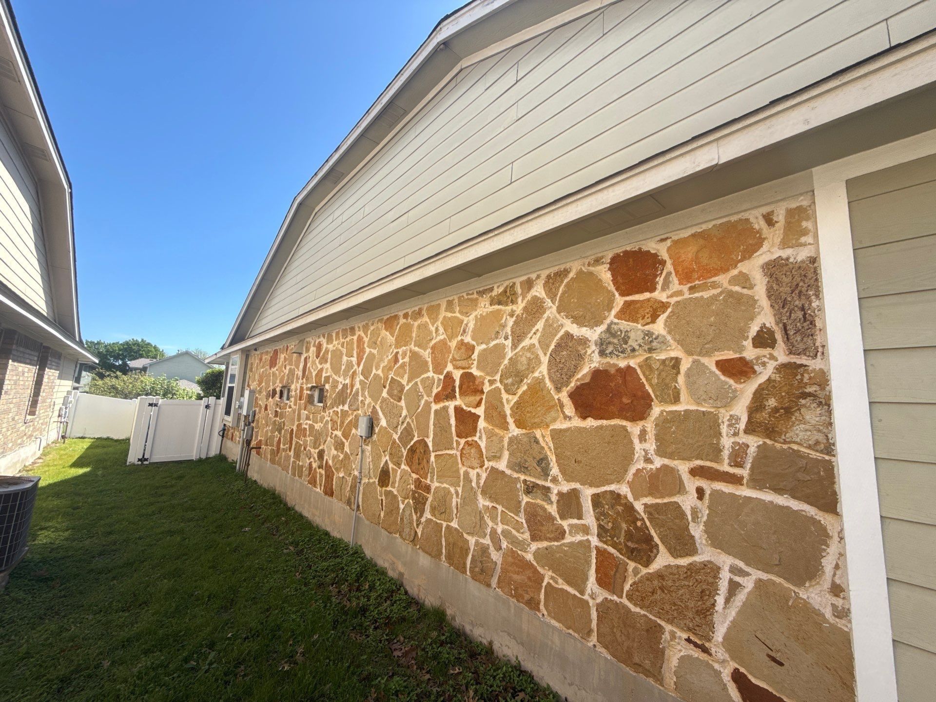 Left side of house ahead of exterior painting in Pflugerville, TX by Hill Country Painting