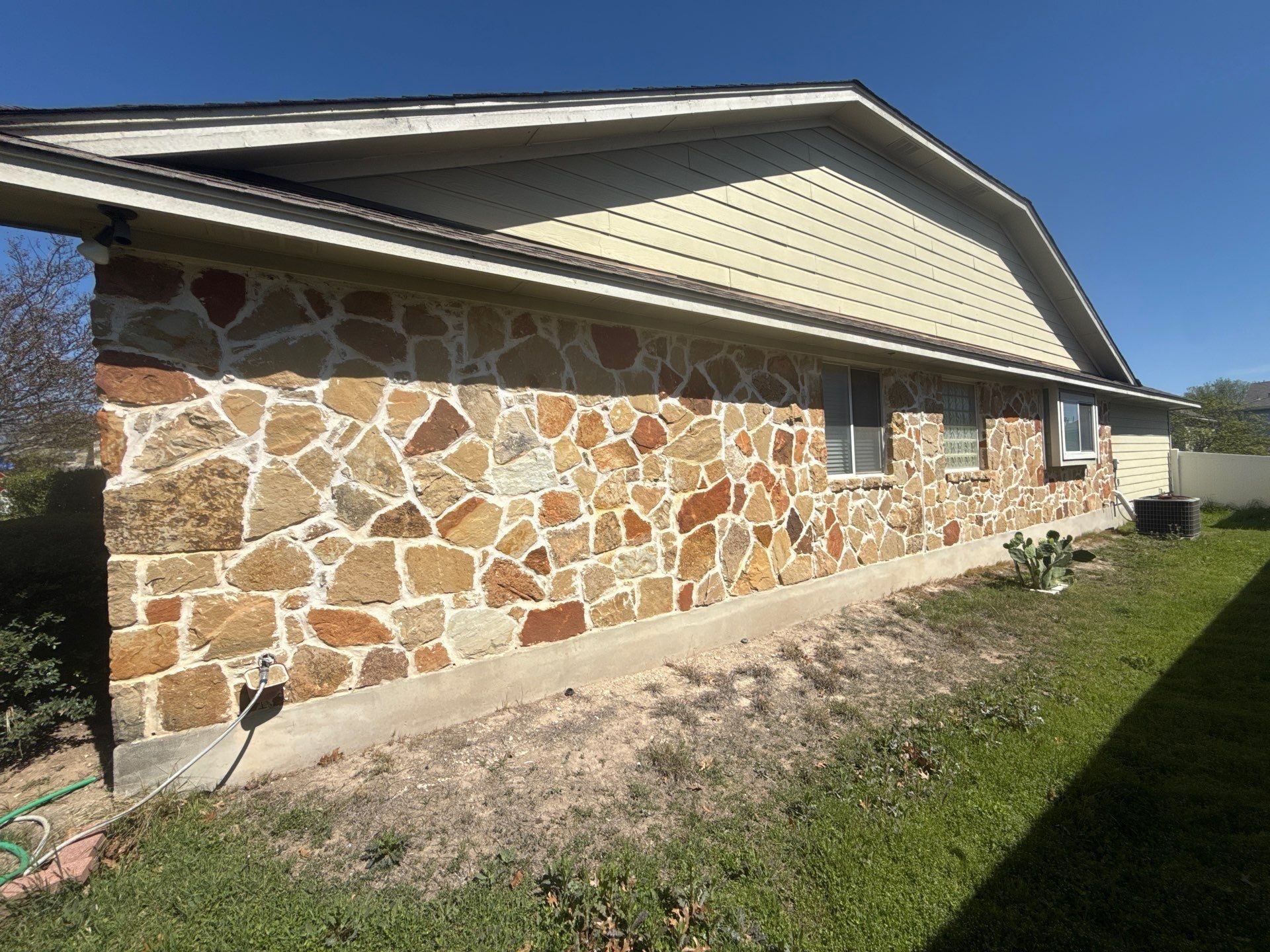 Right side of house ahead of exterior painting in Pflugerville, TX by Hill Country Painting