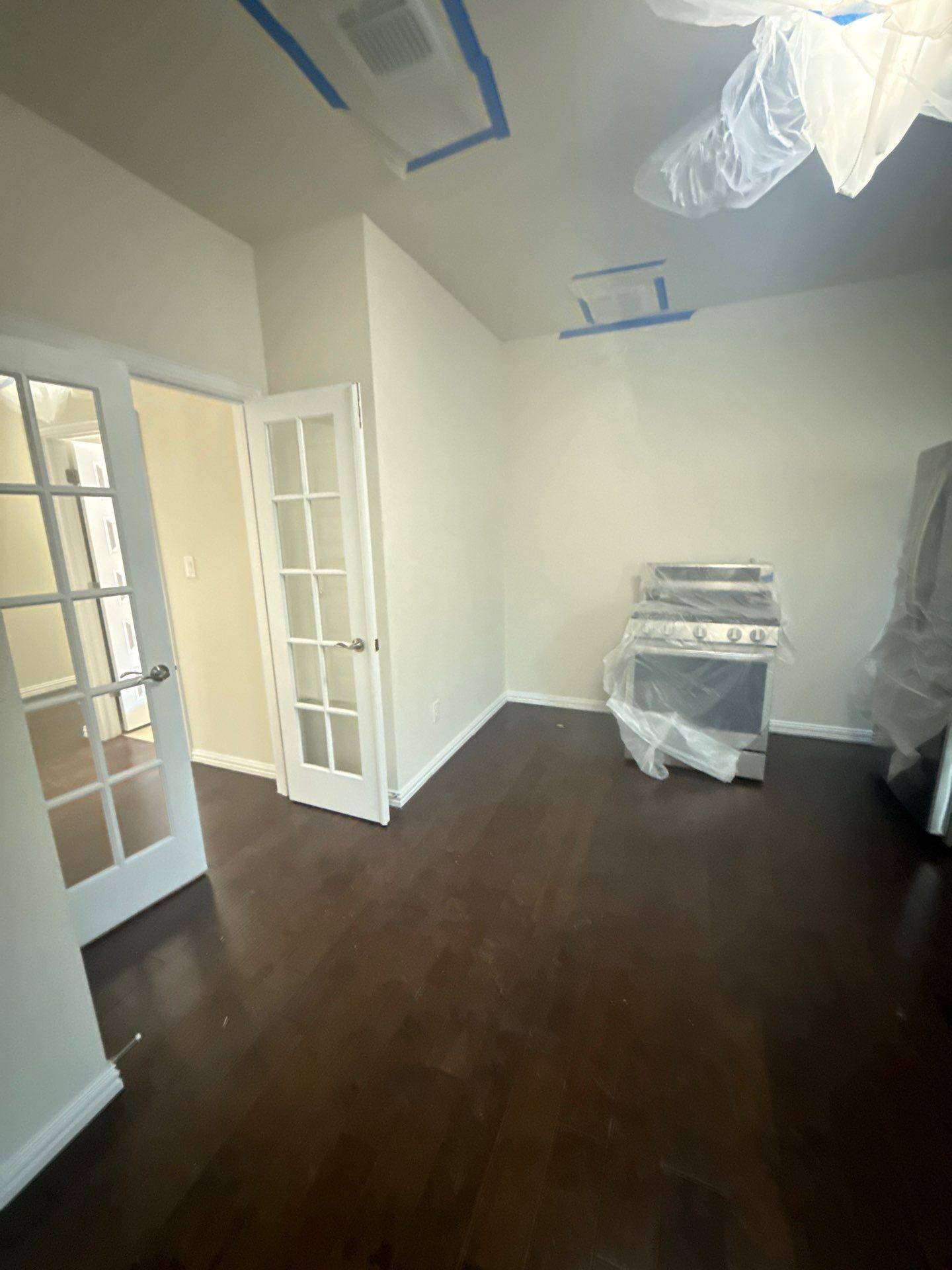 Living room and kitchen area ahead of interior painting in Buda, TX by Hill Country Painting