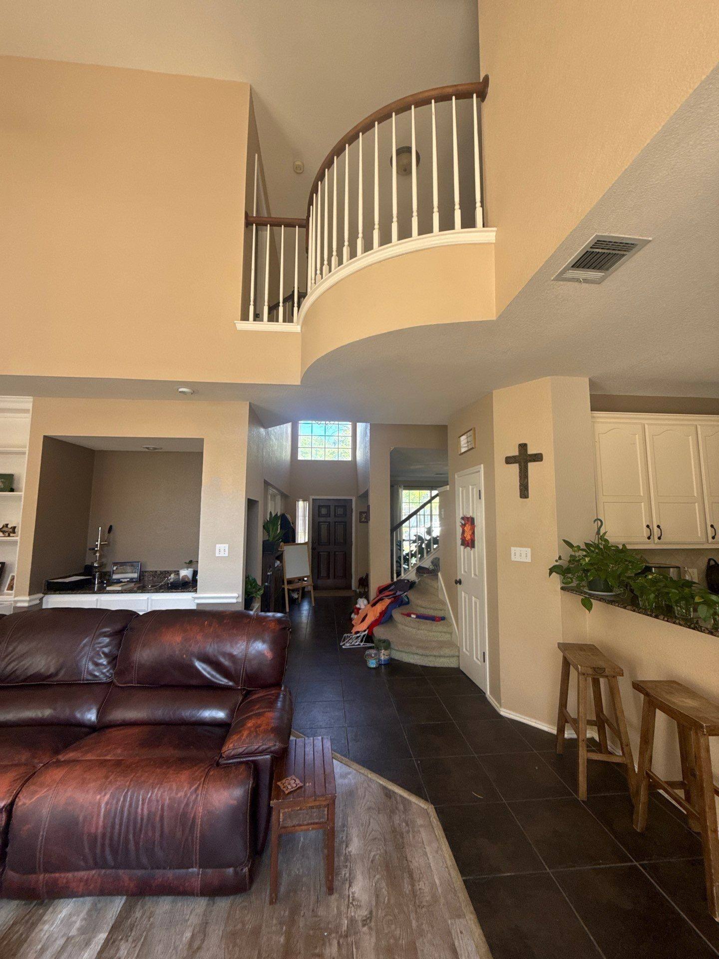 Living room, entry, and stairwell ahead of painting in Round Rock, TX by Hill Country Painting