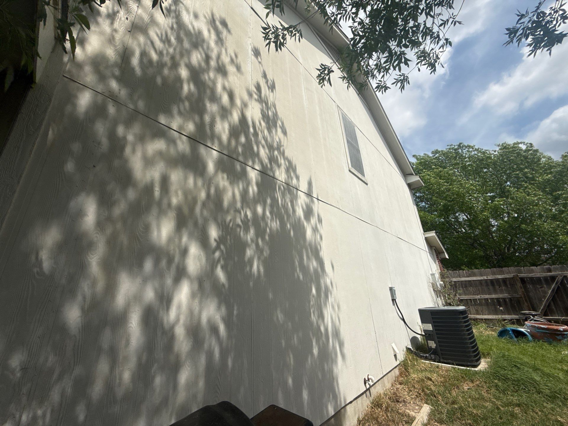 Left side exterior ahead of painting in Hutto, TX by Hill Country Painting