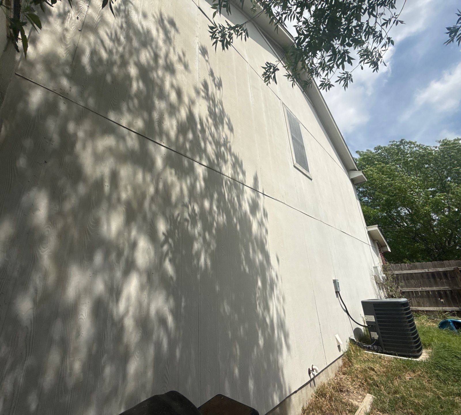 Left side exterior ahead of painting in Hutto, TX by Hill Country Painting