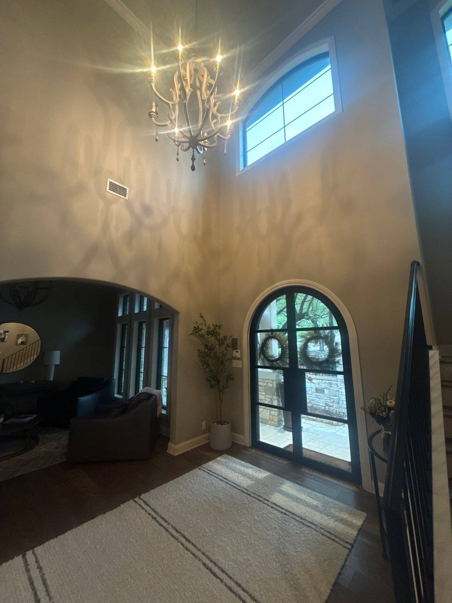 Two-story entryway ahead of painting in Austin, TX by Hill Country Painting
