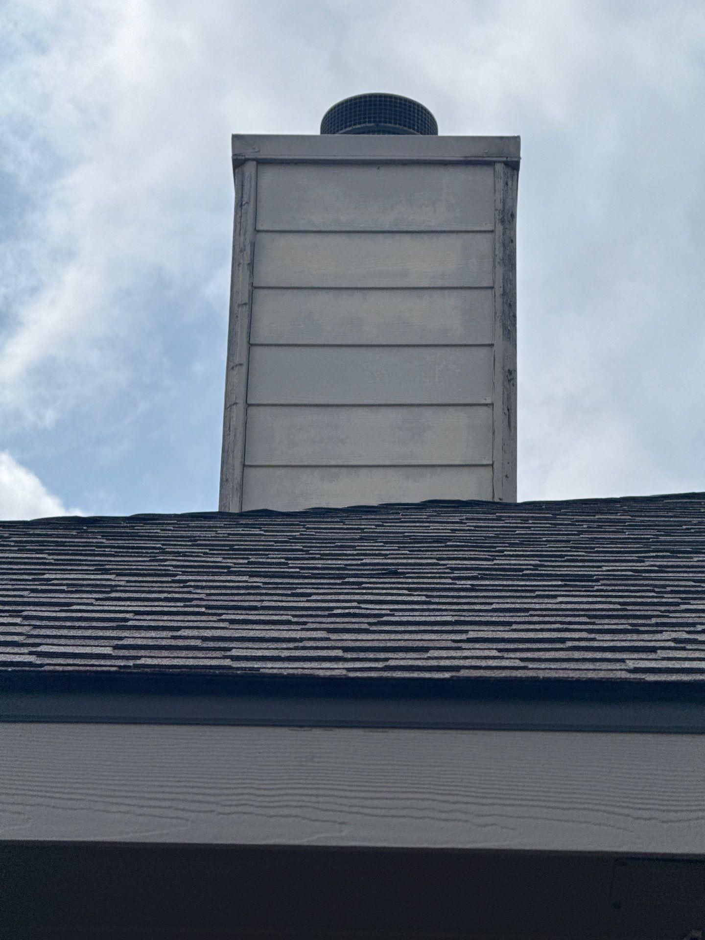 Chimney and roofline ahead of painting in Leander, TX by Hill Country Painting