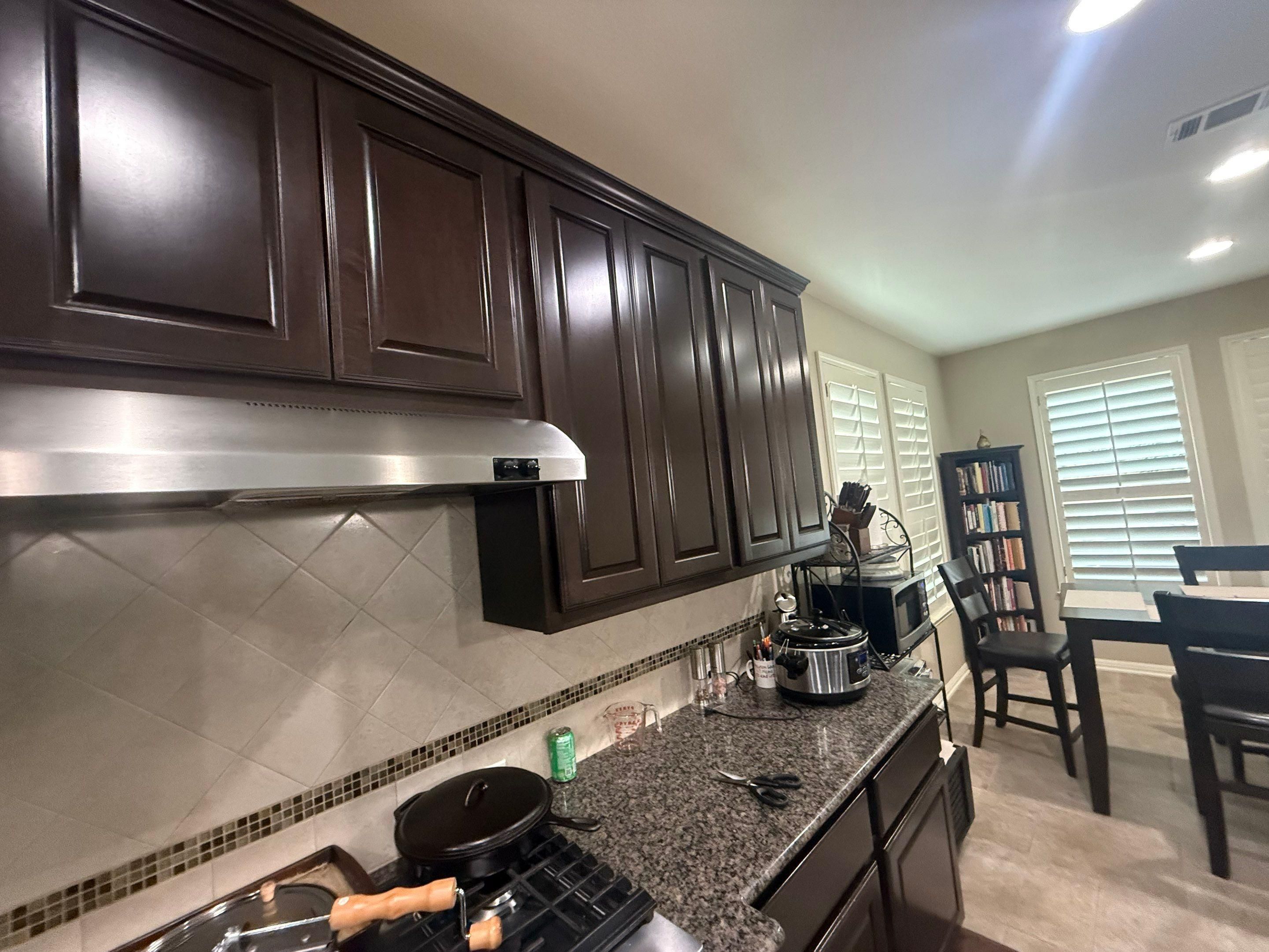 Kitchen cabinetry wide view ahead of refinishing in Georgetown, TX by Hill Country Painting