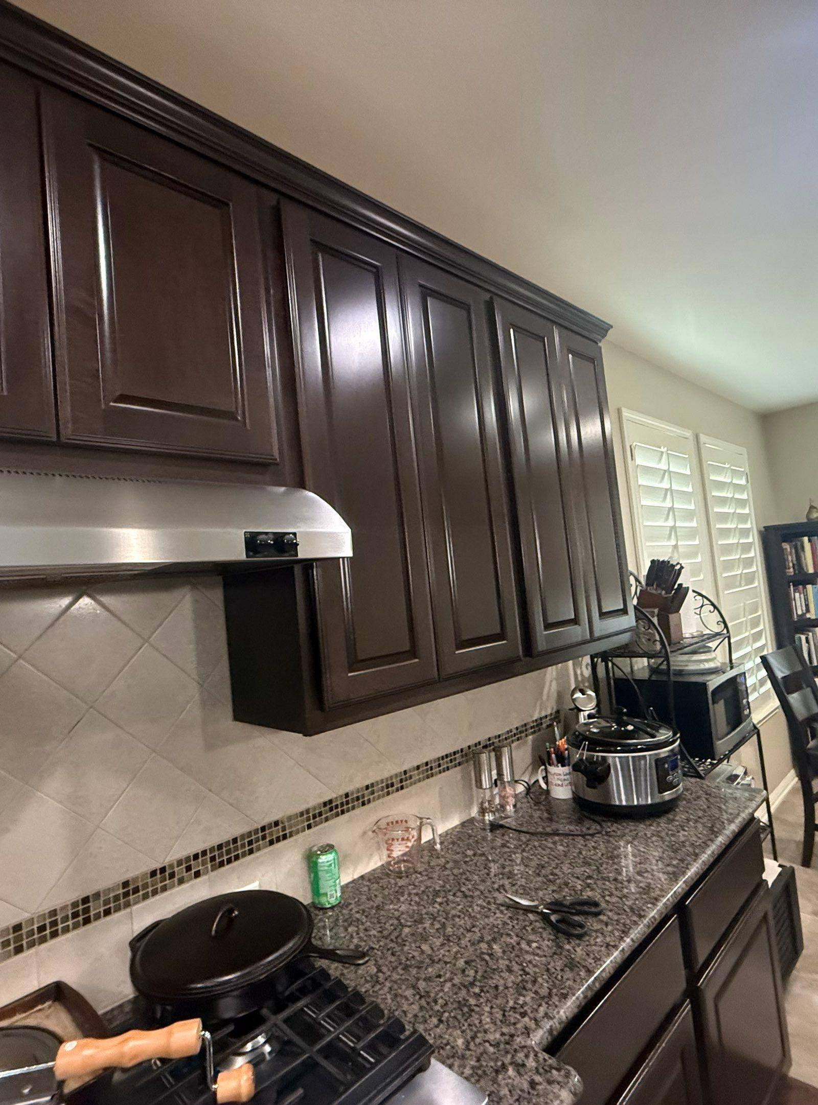 Kitchen cabinetry wide view ahead of refinishing in Georgetown, TX by Hill Country Painting
