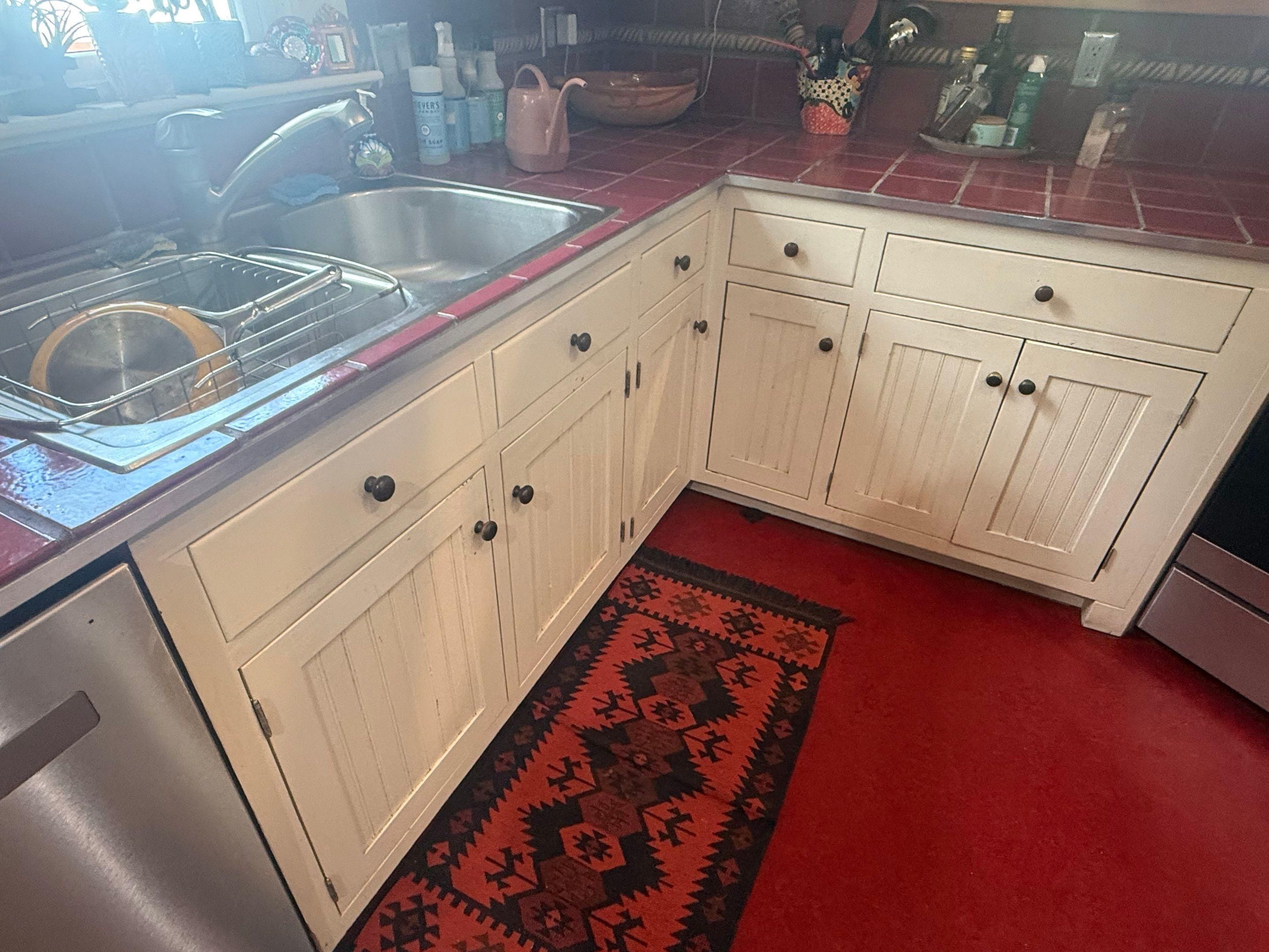 Corner base cabinets ahead of refinishing in Austin, TX by Hill Country Painting