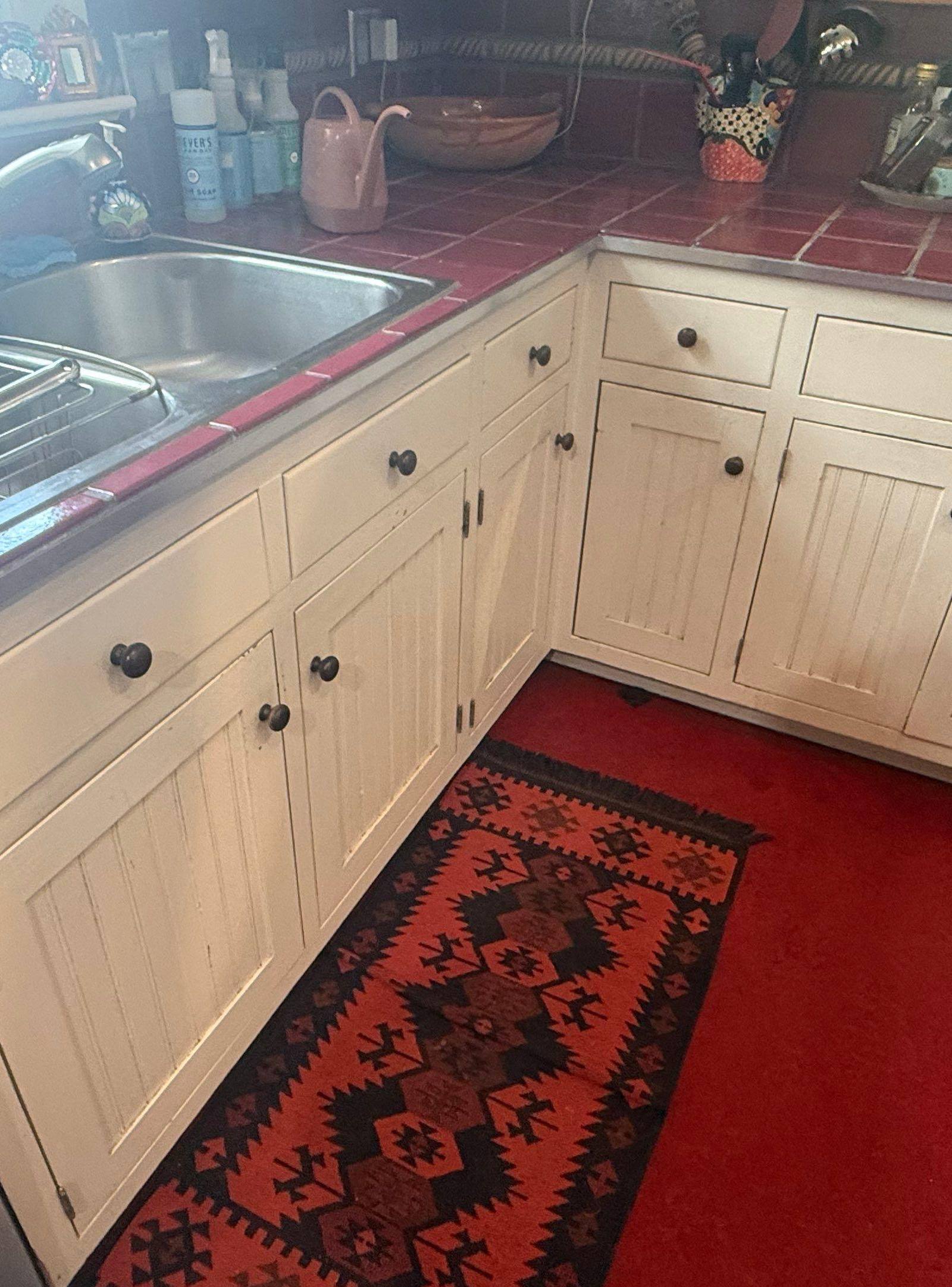 Corner base cabinets ahead of refinishing in Austin, TX by Hill Country Painting