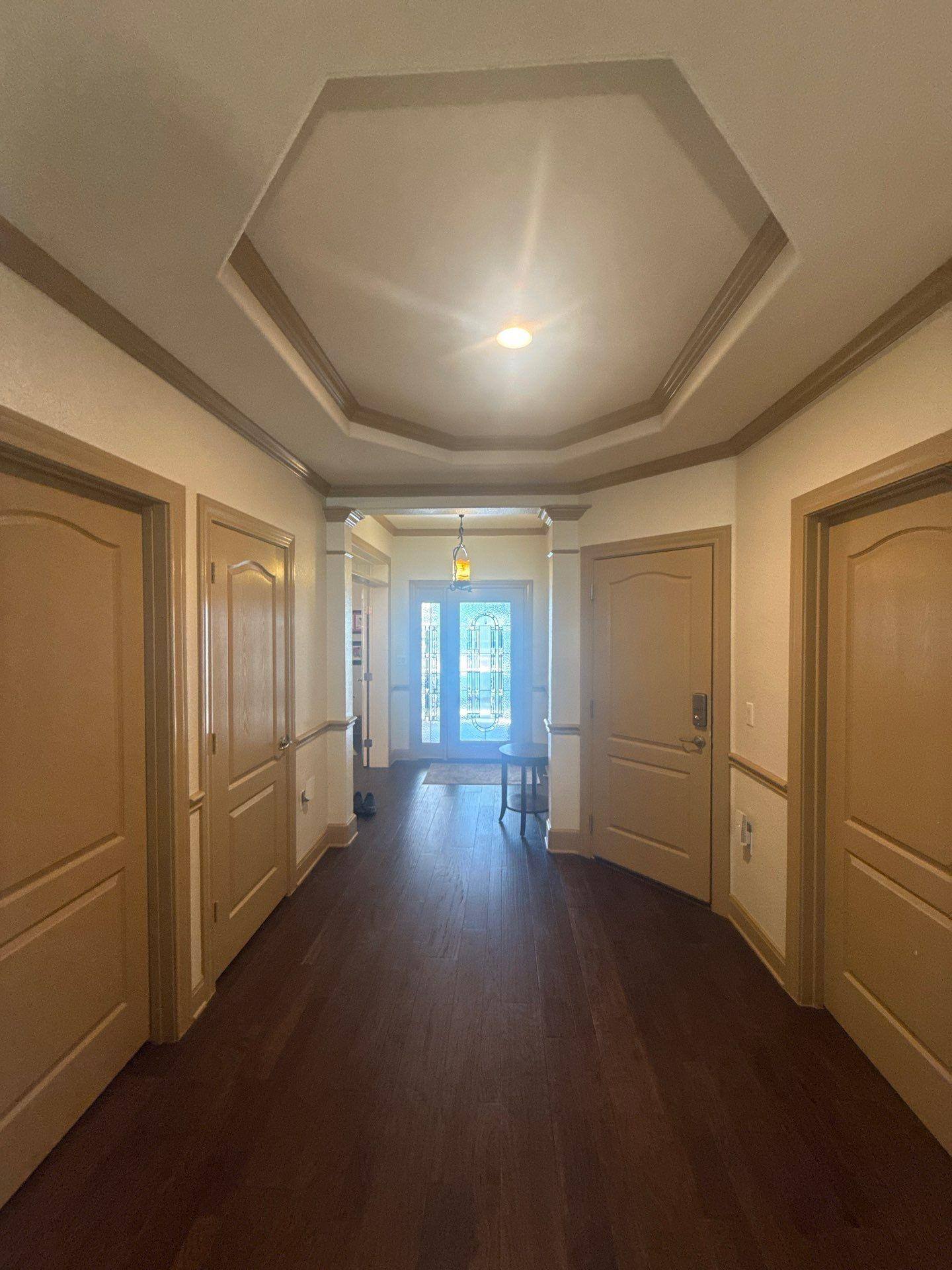 Entryway with crown molding and doors ahead of trim painting in Georgetown, TX by Hill Country Painting