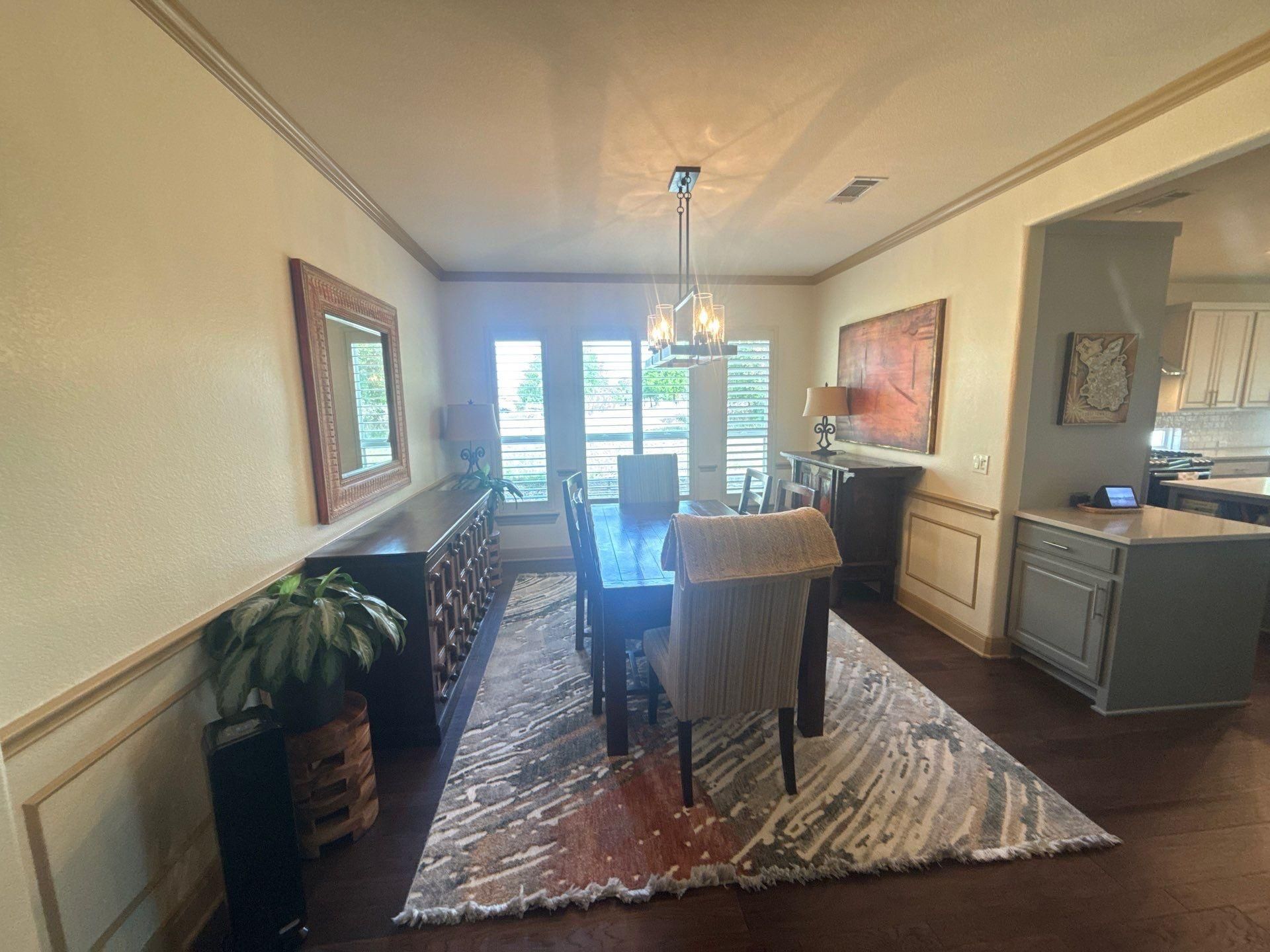 Dining room with chair rail and crown molding ahead of trim painting in Georgetown, TX by Hill Country Painting