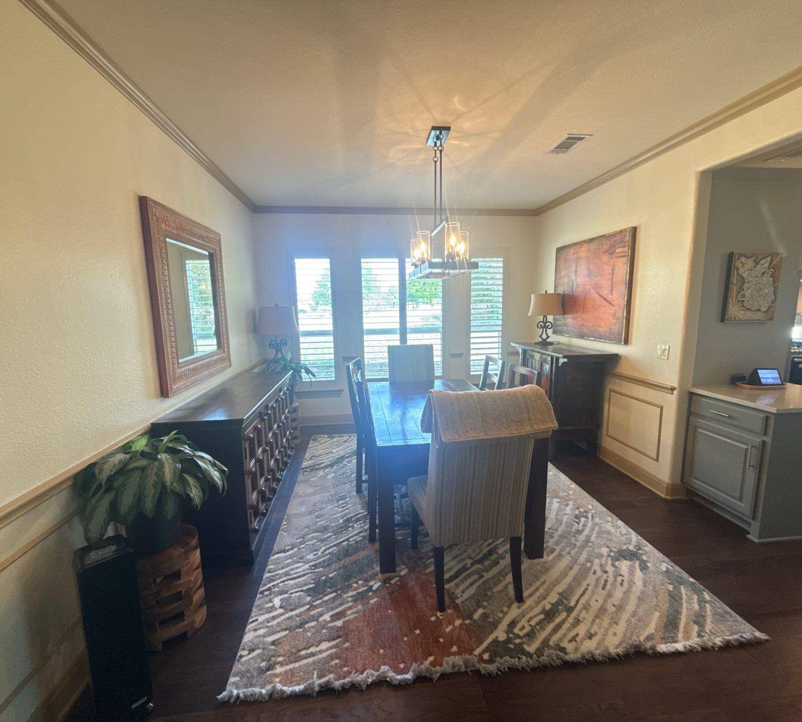 Dining room with chair rail and crown molding ahead of trim painting in Georgetown, TX by Hill Country Painting