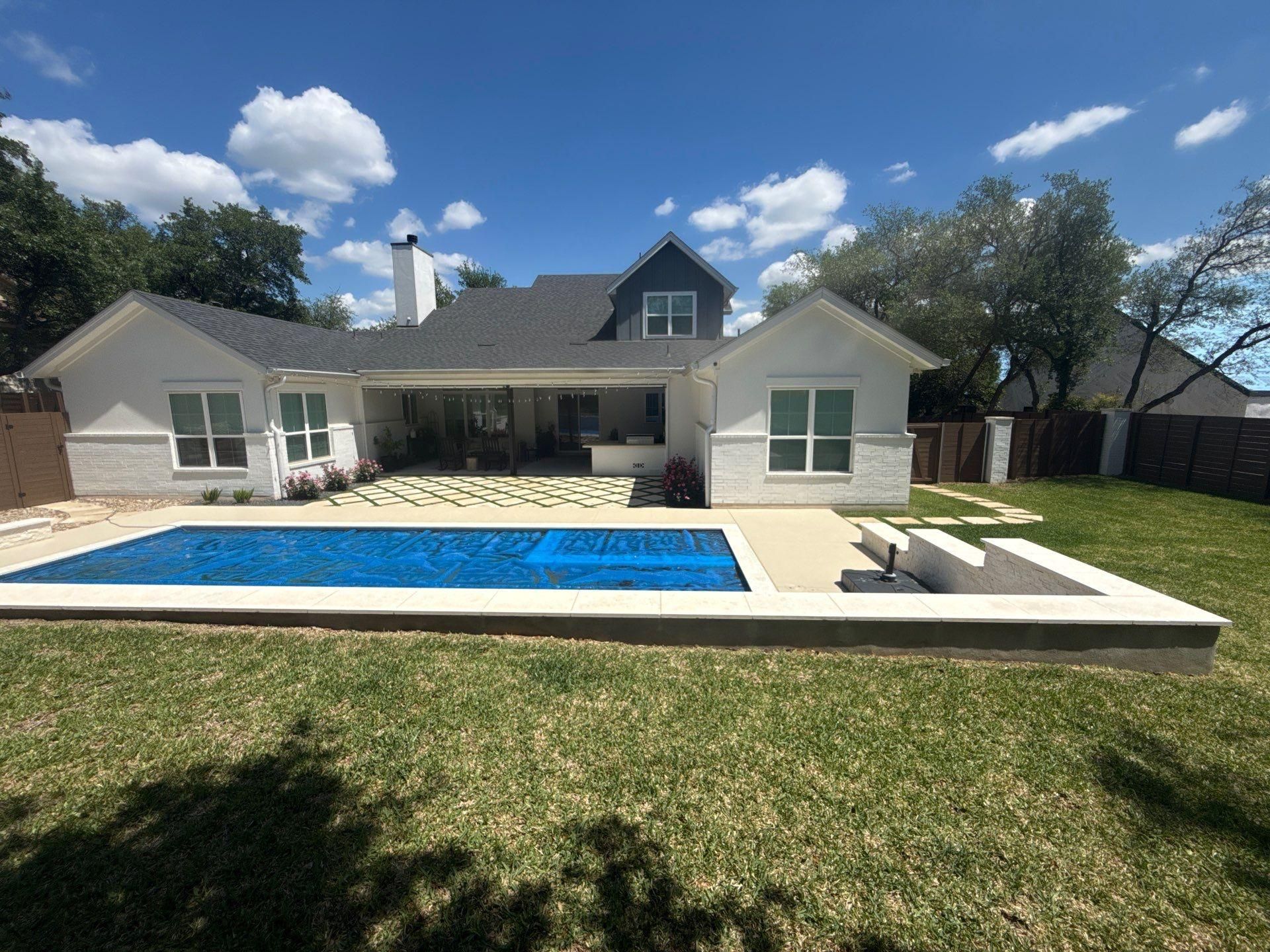 Backyard elevation with chimney ahead of exterior painting in Lakeway, TX by Hill Country Painting
