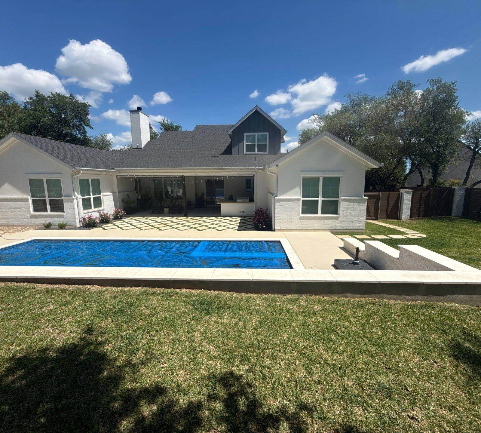 Backyard elevation with chimney ahead of exterior painting in Lakeway, TX by Hill Country Painting