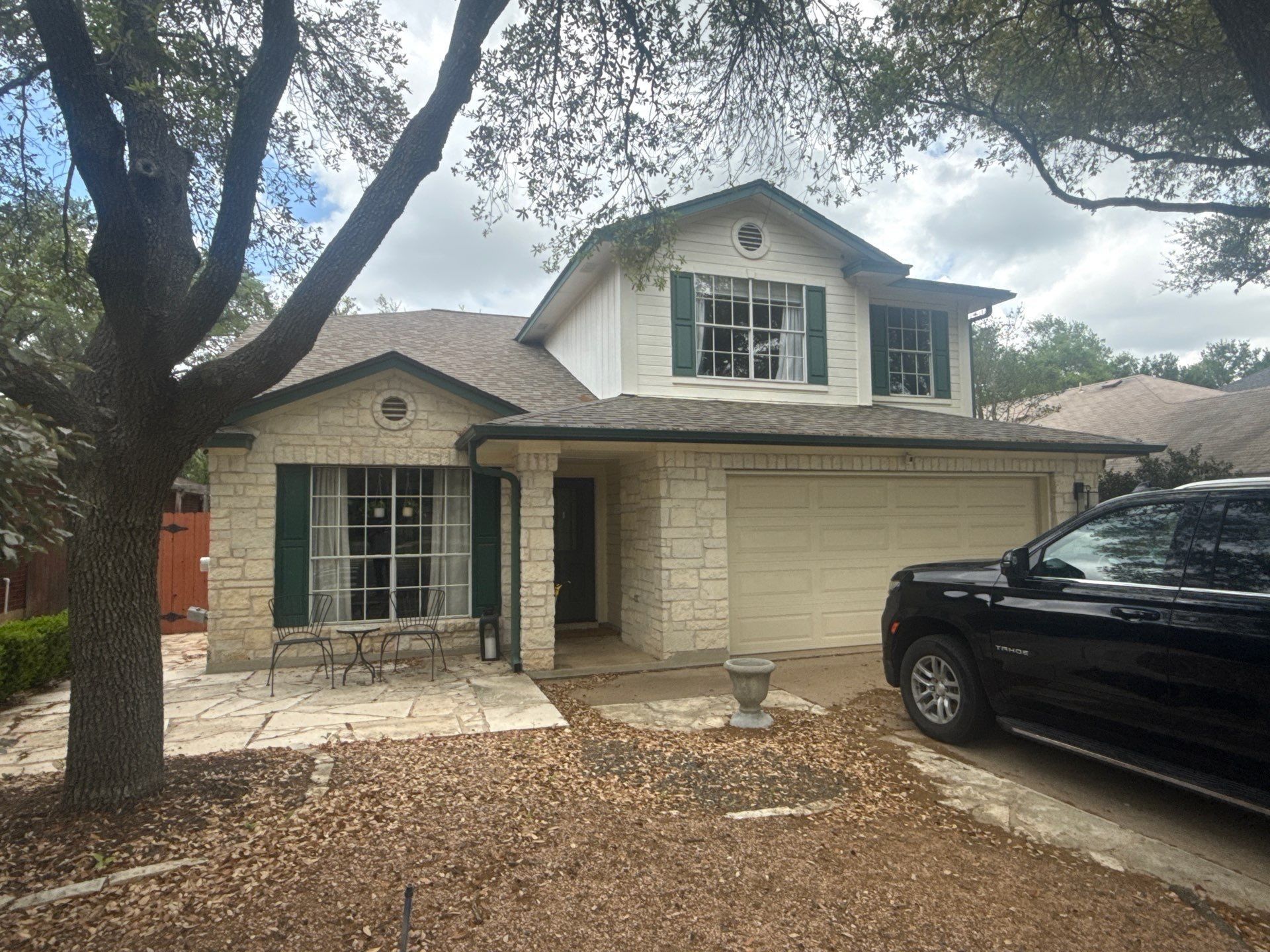 Front elevation of a stone and siding home ahead of exterior painting in Austin, TX by Hill Country Painting