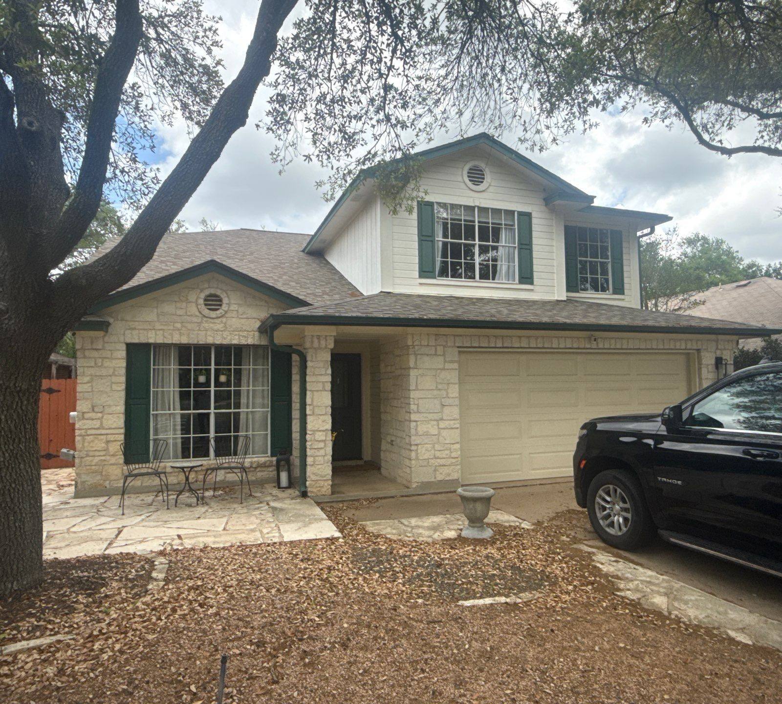 Front elevation of a stone and siding home ahead of exterior painting in Austin, TX by Hill Country Painting