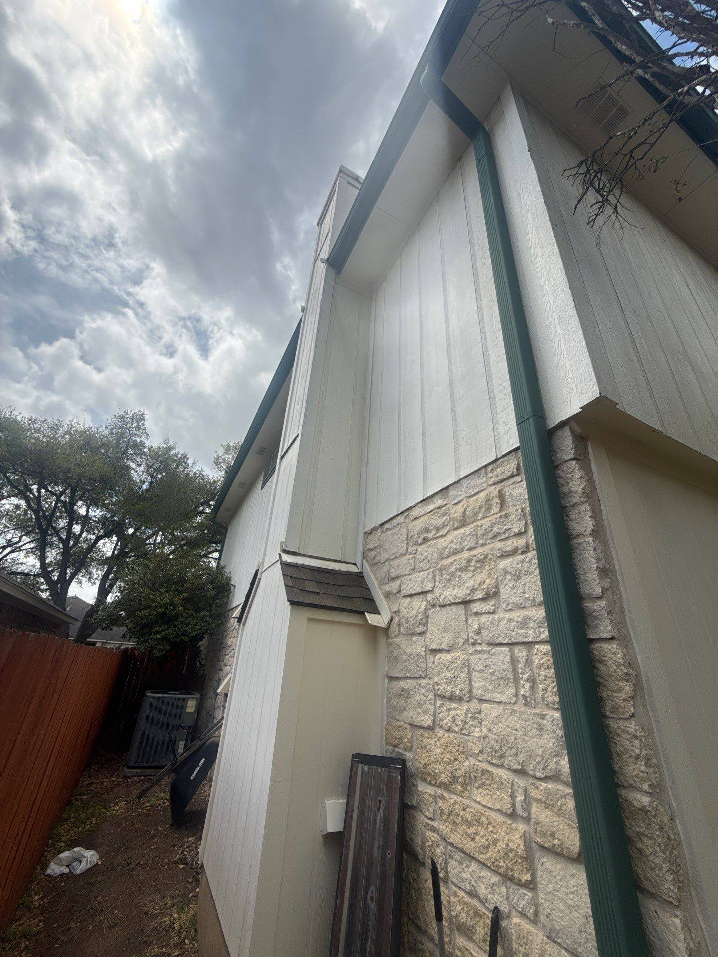 Side elevation with stone siding ahead of exterior painting in Austin, TX by Hill Country Painting