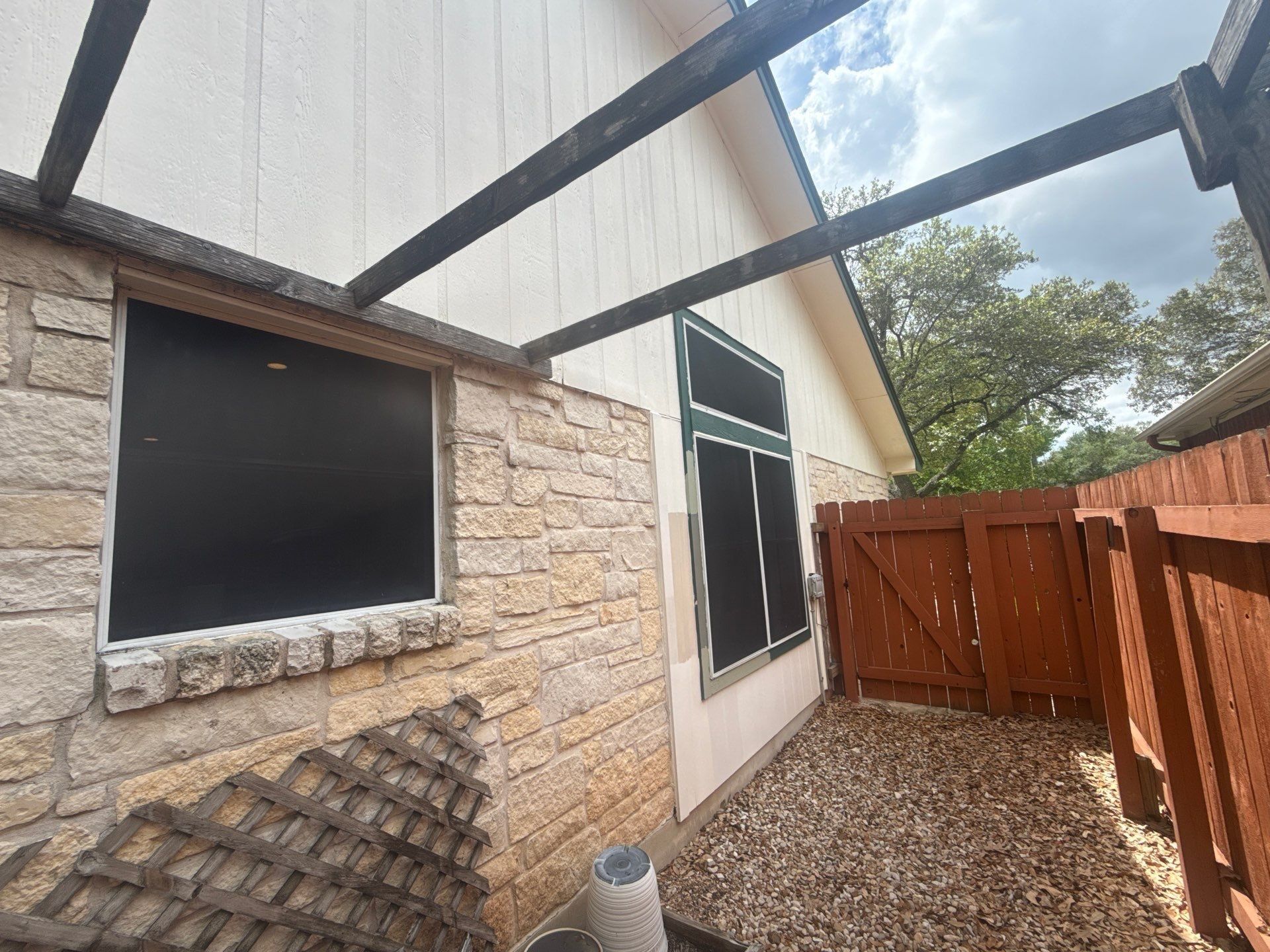 Side yard walkway and gate ahead of exterior painting in Austin, TX by Hill Country Painting