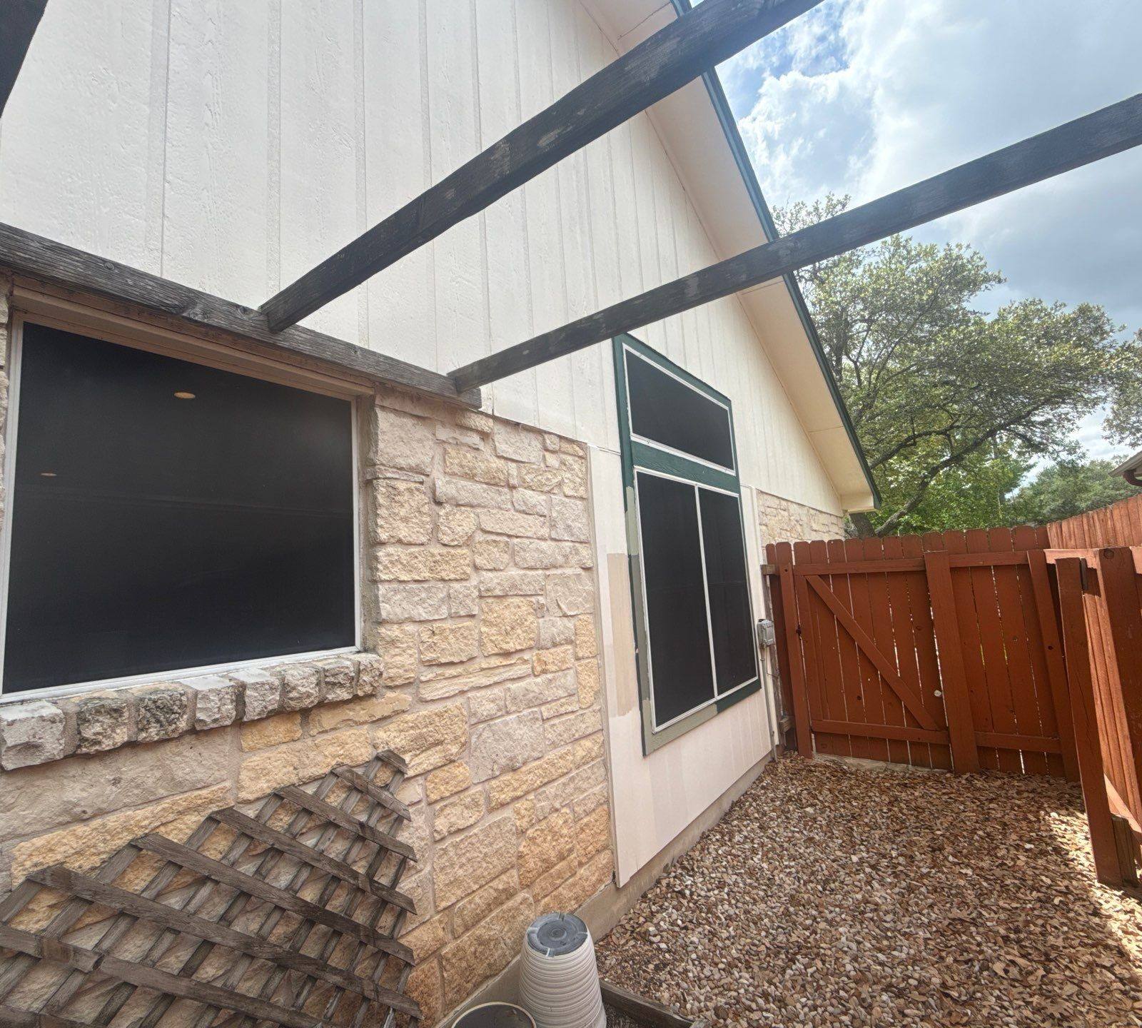 Side yard walkway and gate ahead of exterior painting in Austin, TX by Hill Country Painting