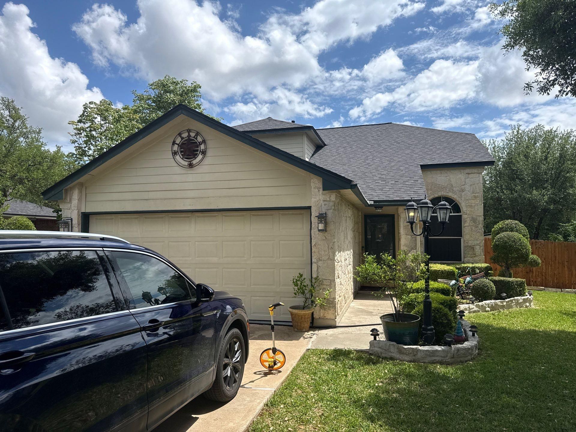 Front elevation of a stone and siding home ahead of exterior painting in Cedar Park, TX by Hill Country Painting