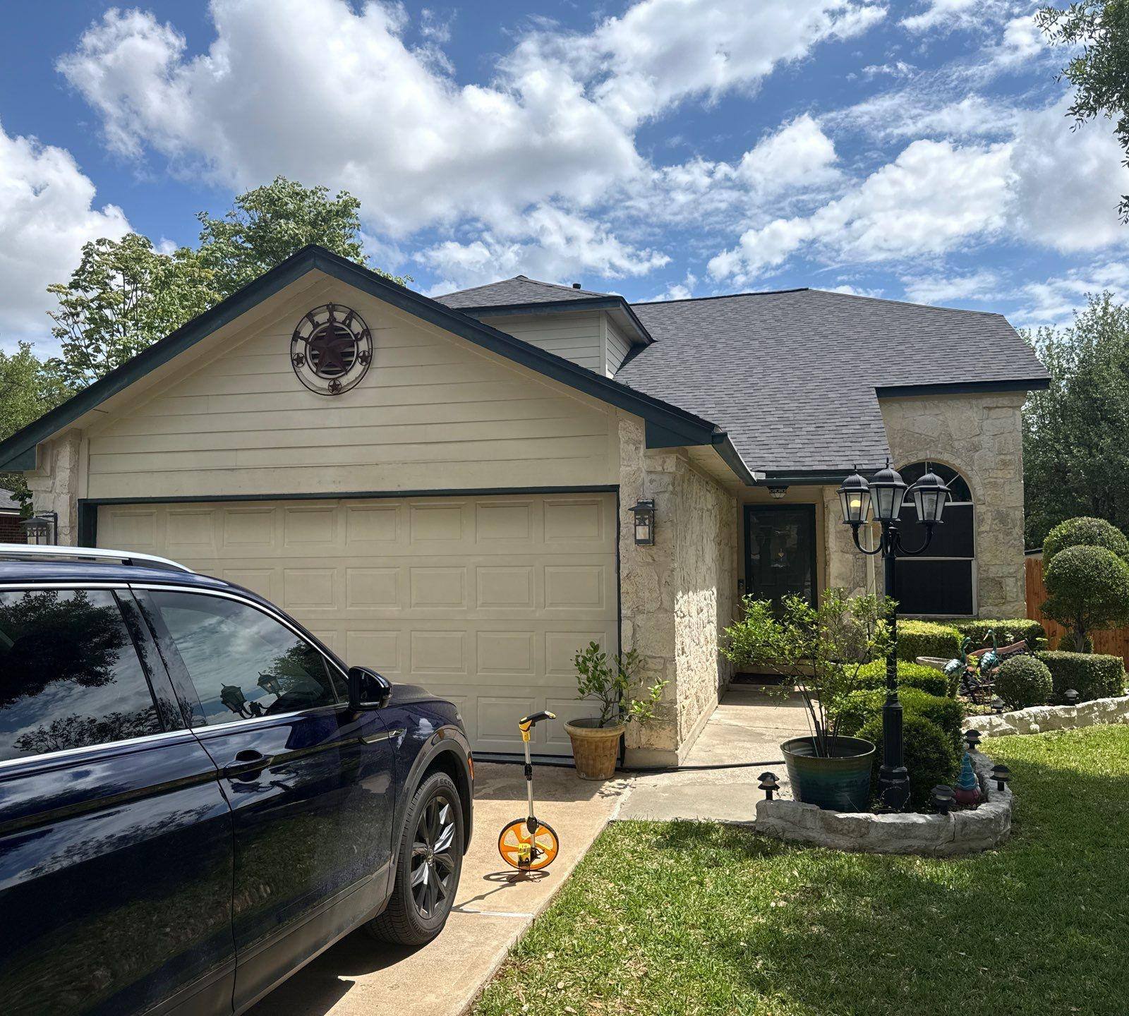 Front elevation of a stone and siding home ahead of exterior painting in Cedar Park, TX by Hill Country Painting