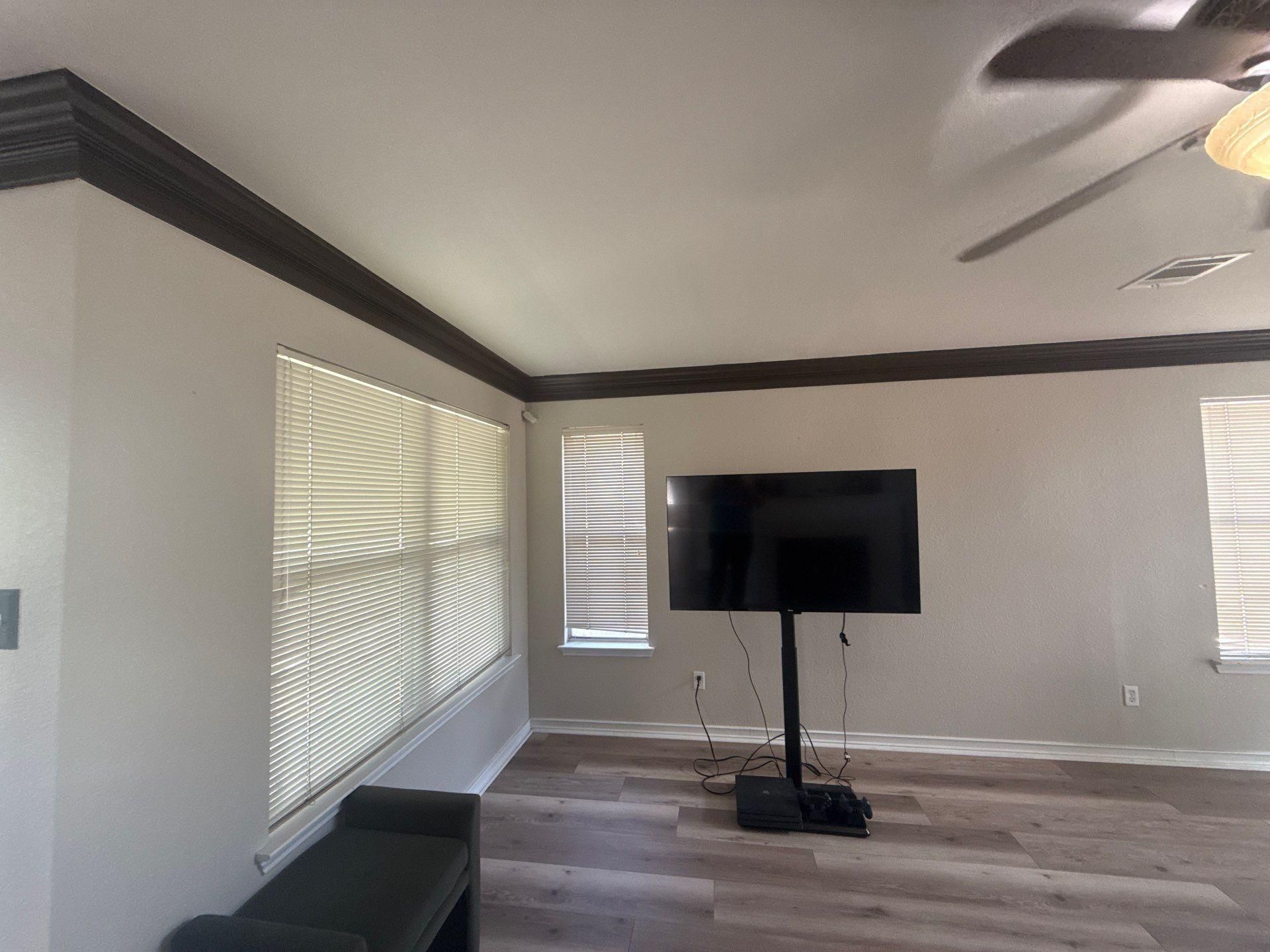 Living room with crown molding ahead of painting in Austin, TX by Hill Country Painting