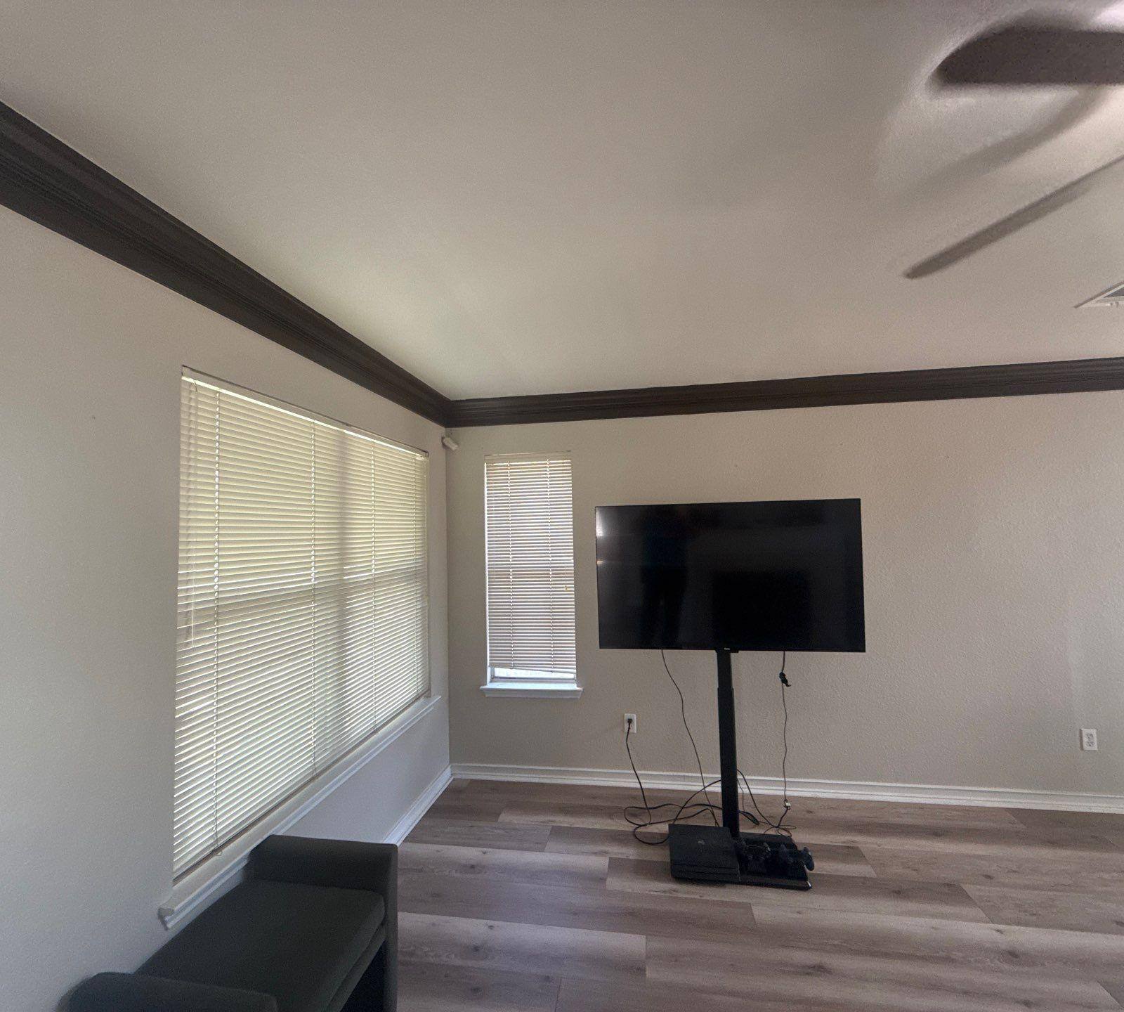 Living room with crown molding ahead of painting in Austin, TX by Hill Country Painting