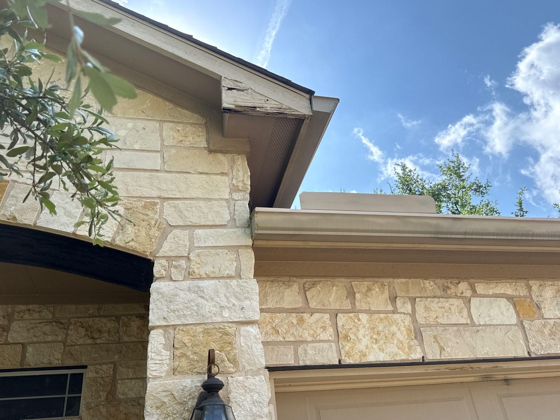 Front porch stone column and soffit detail ahead of exterior painting in Cedar Park, TX by Hill Country Painting