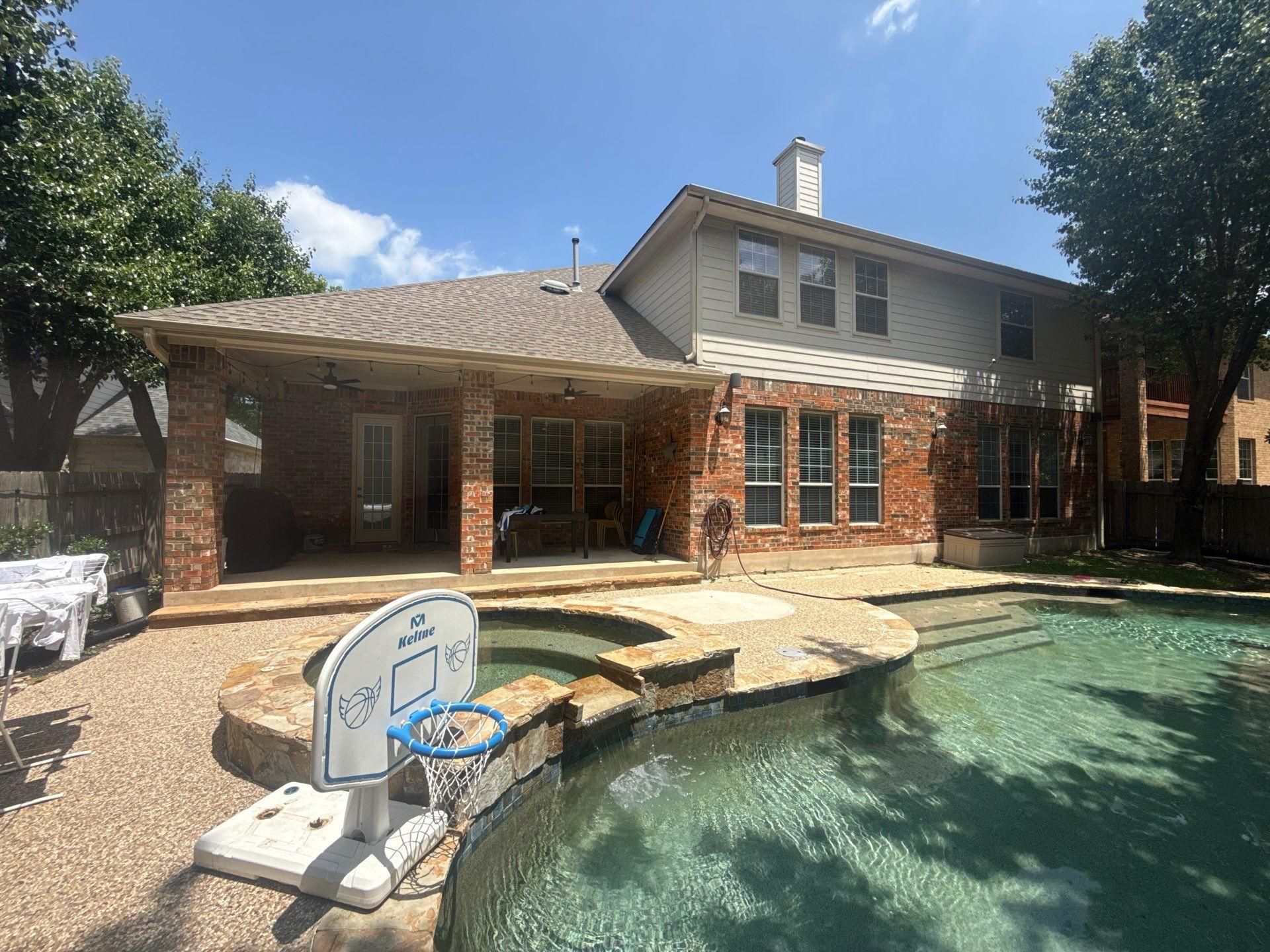 Back of a Cedar Park, TX home with covered patio, ahead of exterior painting by Hill Country Painting
