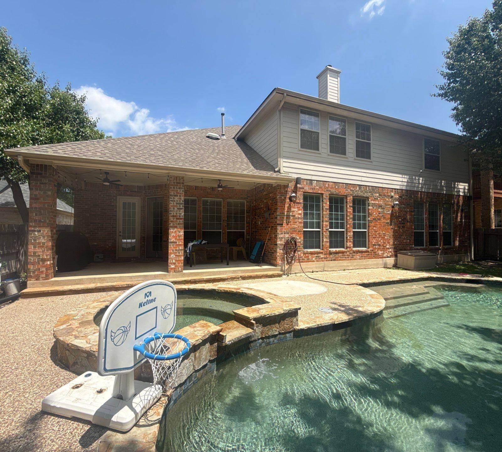 Back of a Cedar Park, TX home with covered patio, ahead of exterior painting by Hill Country Painting