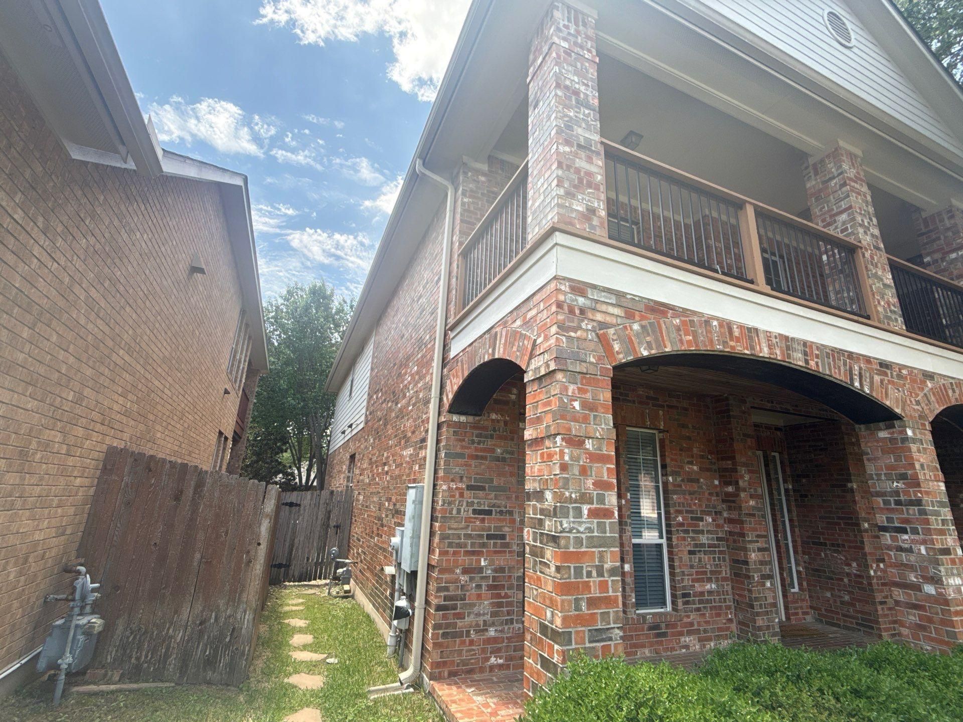 Brick corner detail with covered balcony at a home in Cedar Park, TX painted by Hill Country Painting