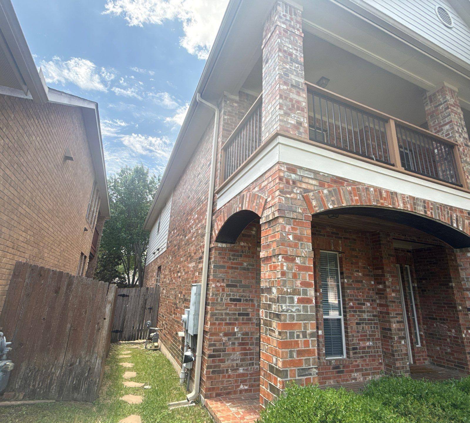 Brick corner detail with covered balcony at a home in Cedar Park, TX painted by Hill Country Painting