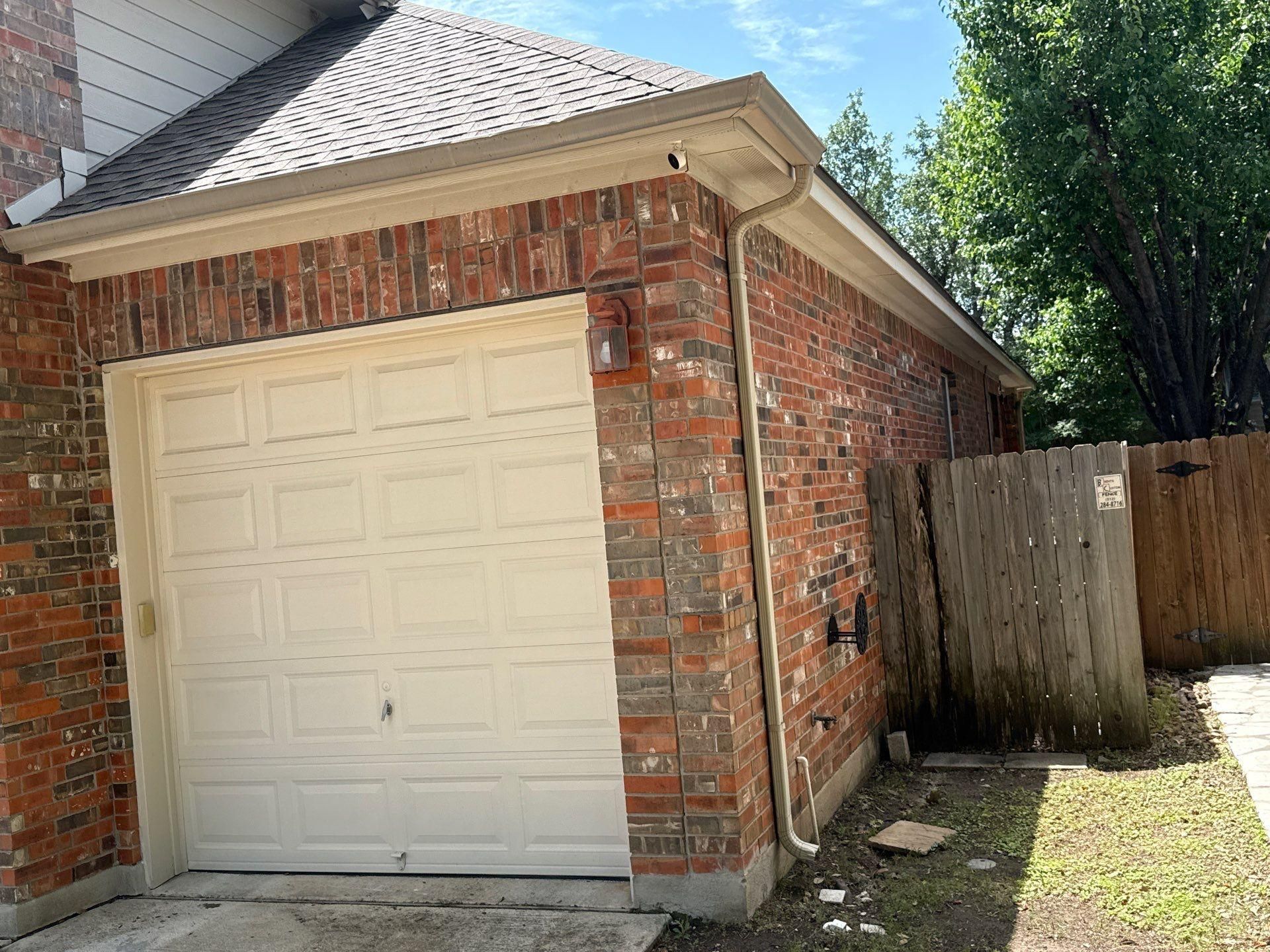 Garage and side elevation at a home in Cedar Park, TX ahead of exterior painting by Hill Country Painting
