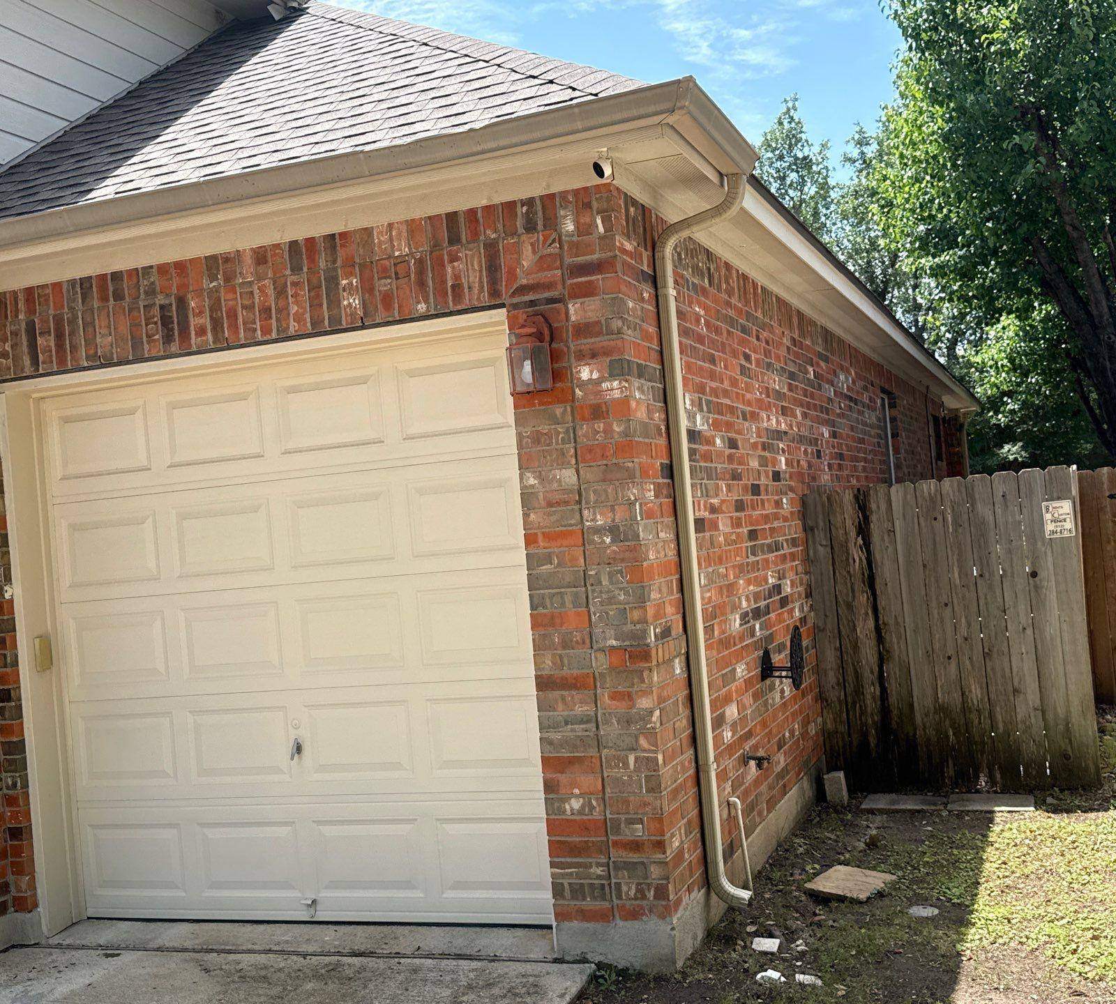 Garage and side elevation at a home in Cedar Park, TX ahead of exterior painting by Hill Country Painting