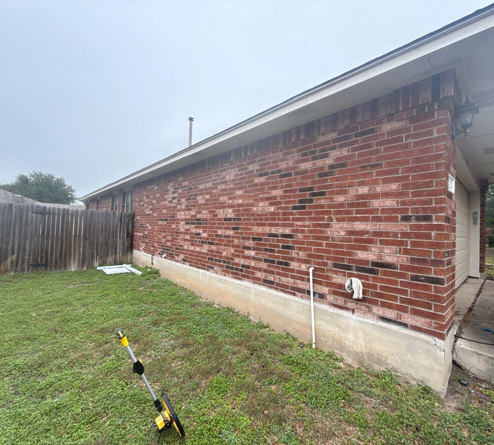 Side elevation of a home in Round Rock, TX visited by Hill Country Painting