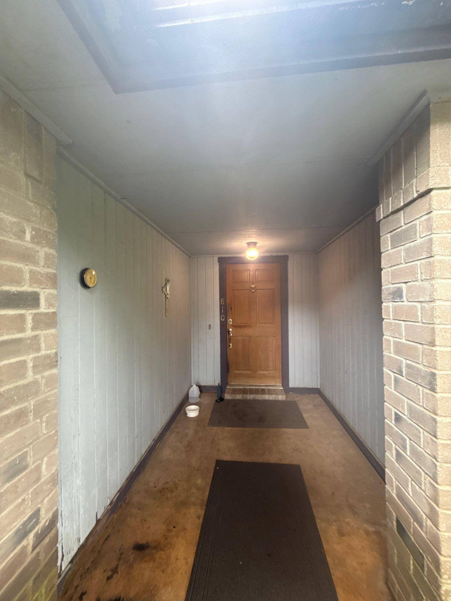 Covered front entry of a home in Pflugerville, TX ahead of painting by Hill Country Painting