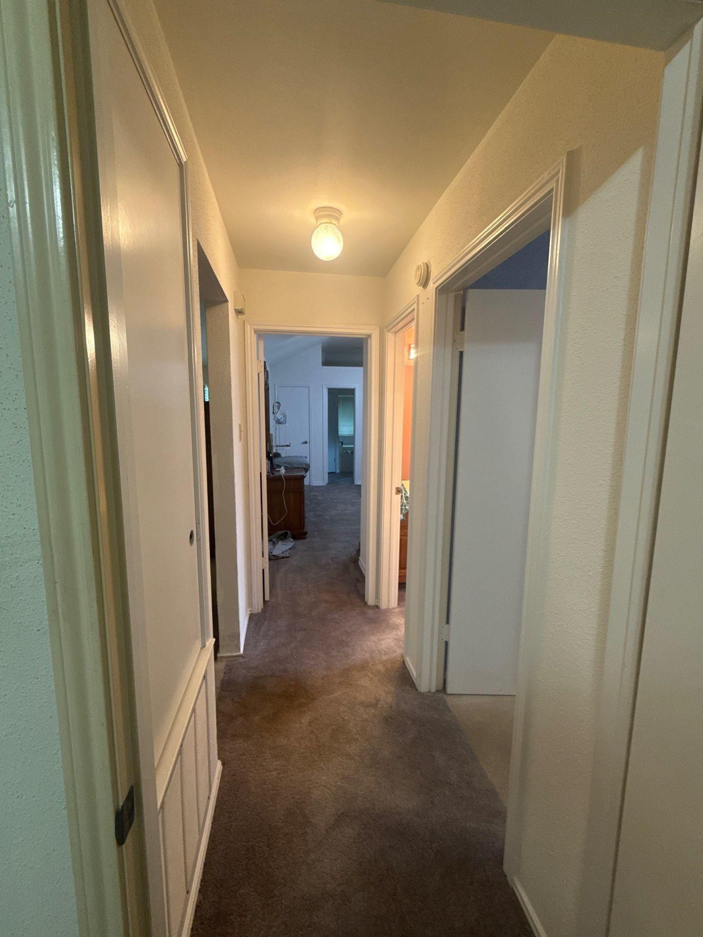 Interior hallway ahead of painting at a home in Pflugerville, TX by Hill Country Painting
