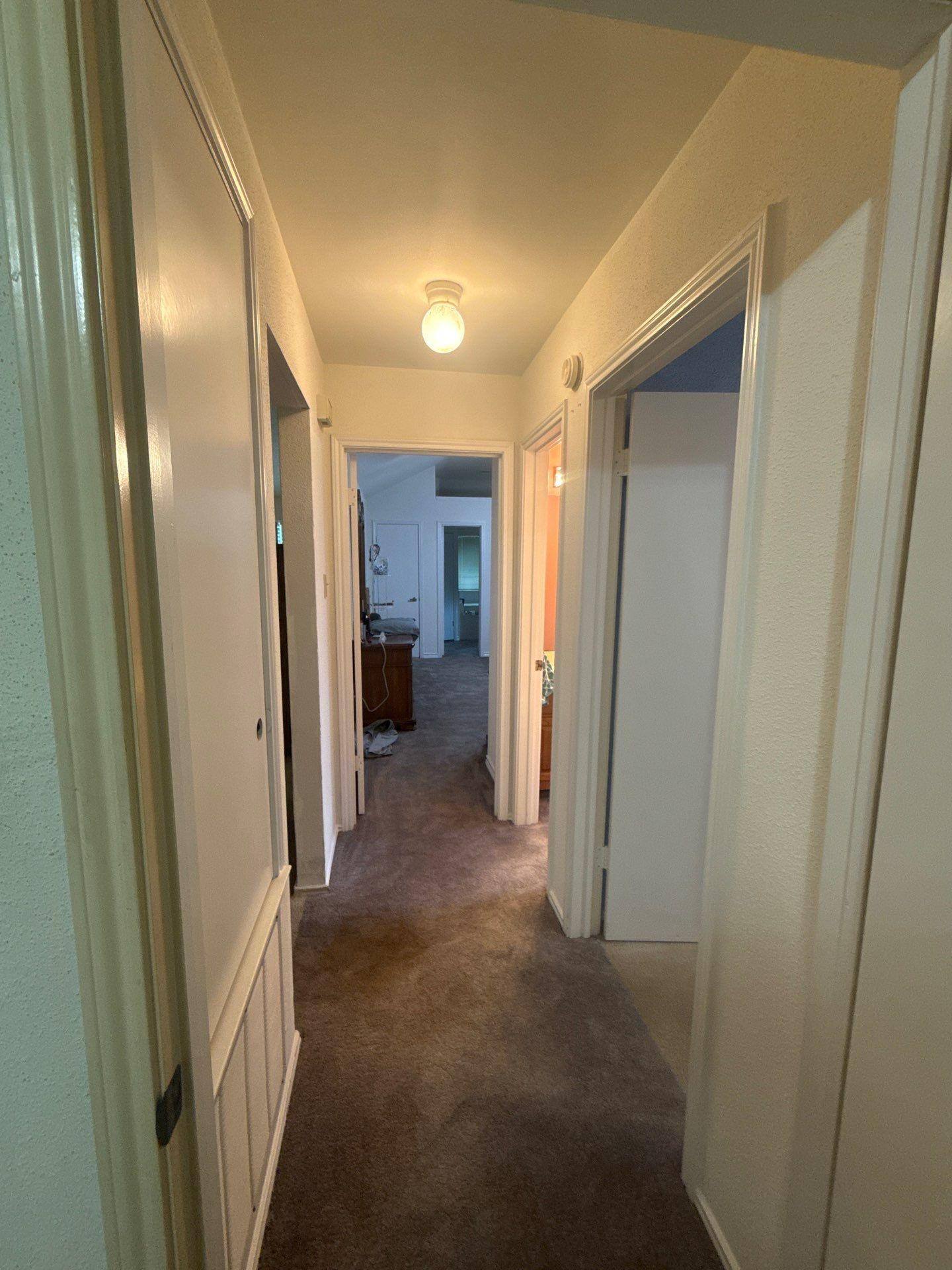 Interior hallway ahead of painting at a home in Pflugerville, TX by Hill Country Painting