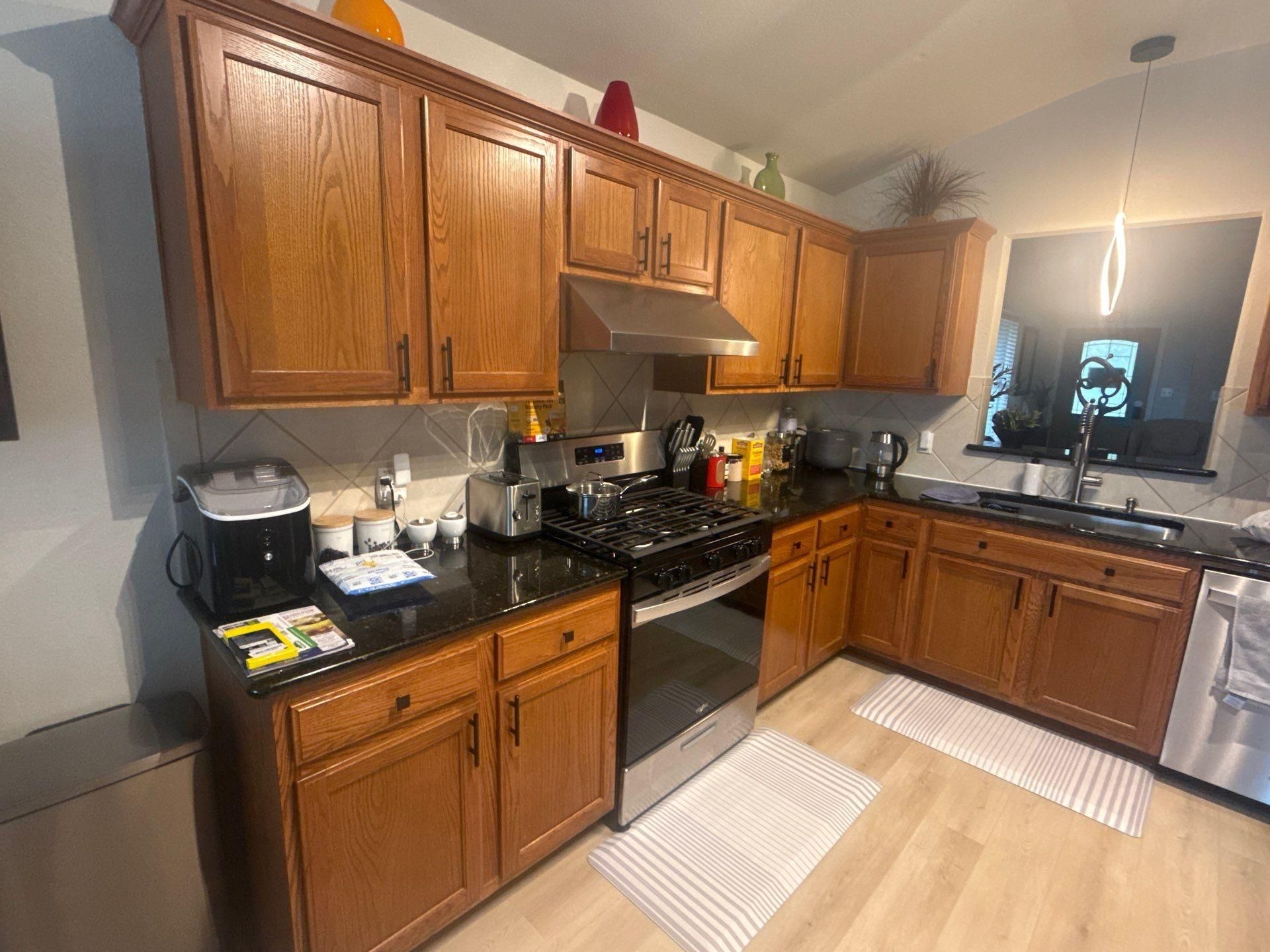 Kitchen cabinets of a home in Austin, TX ahead of cabinet refinishing by Hill Country Painting